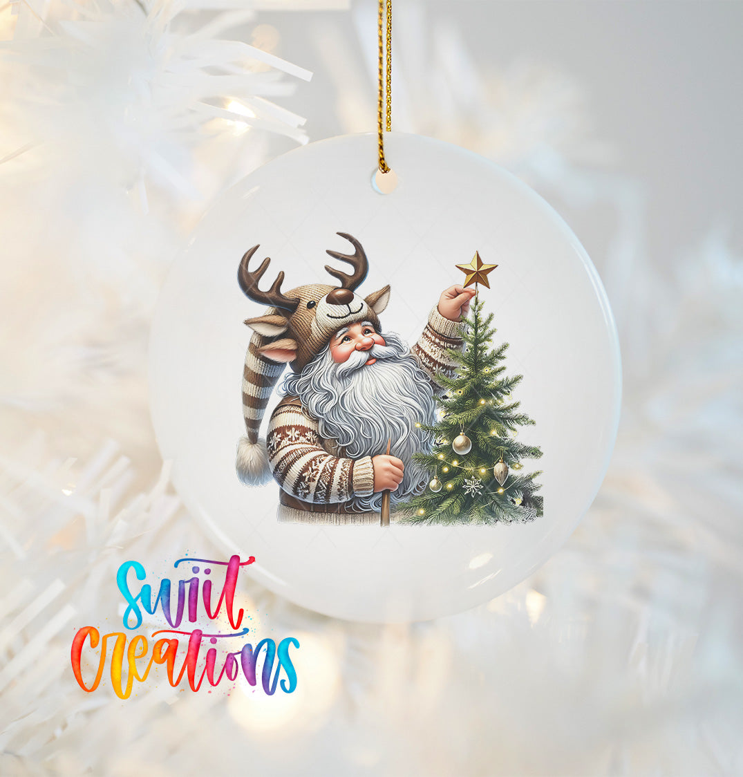 A white ornament featuring a Santa Claus figure holding a Christmas tree and a reindeer, with a star on top of the tree.