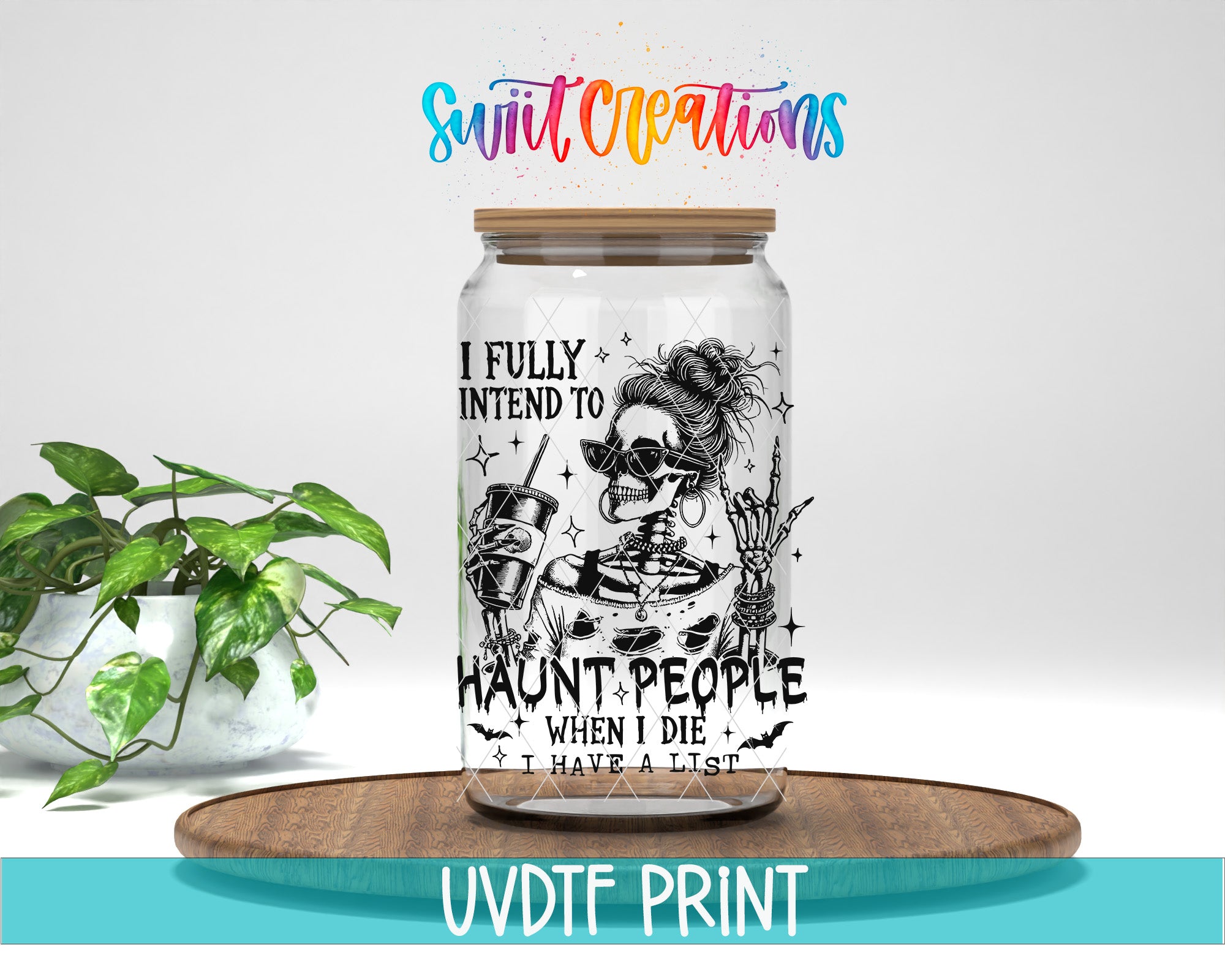 A glass jar with a Halloween-themed design, including a skeleton, skeleton mask, and skull, along with the text "I FULLY INTEND TO HAUNT PEOPLE WHEN I DIE I HAVE A LIST" printed on it. The jar is placed on a wooden tray, and there is a potted plant in the background.