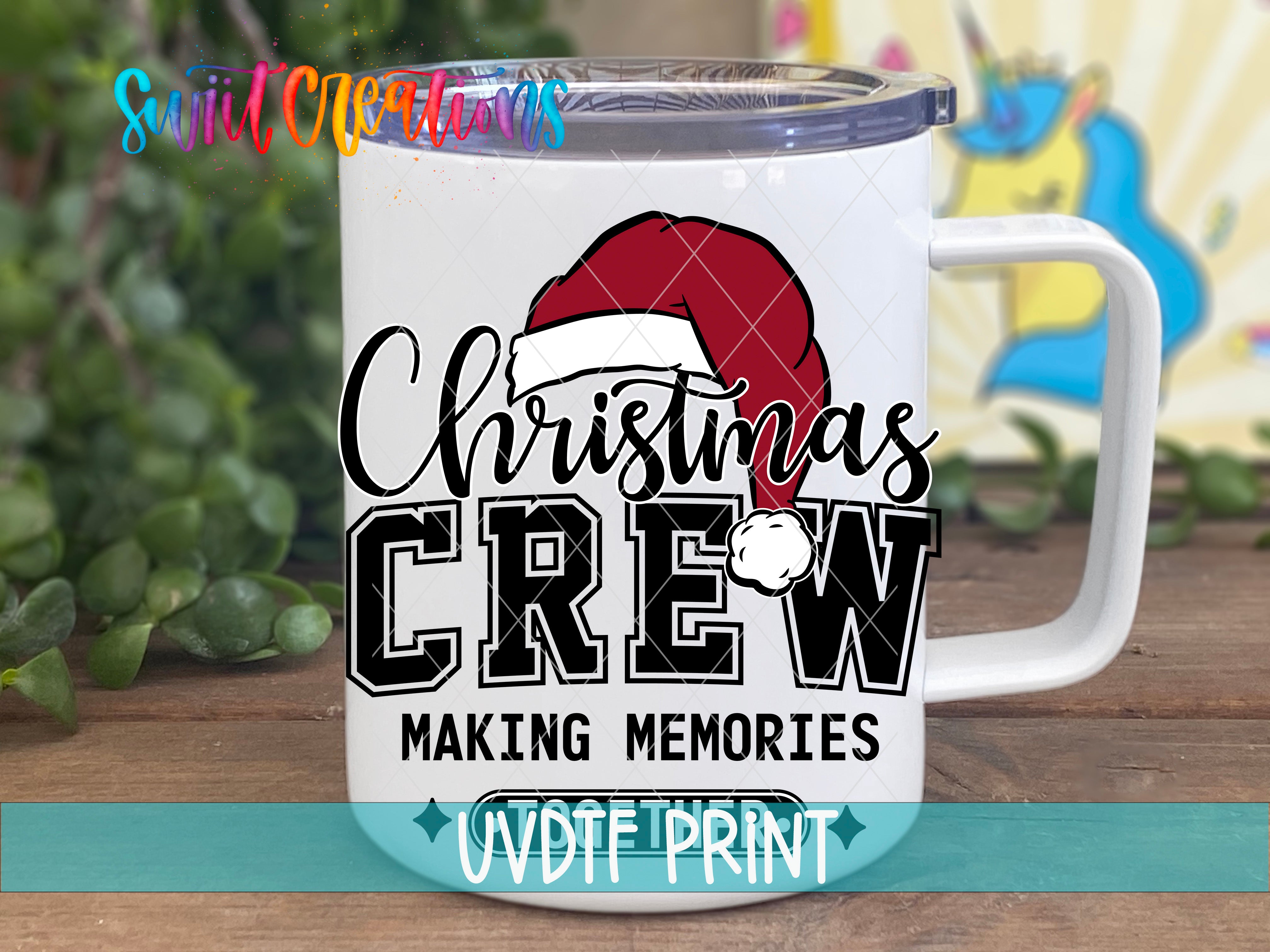 a christmas crew mug sitting on top of a wooden table