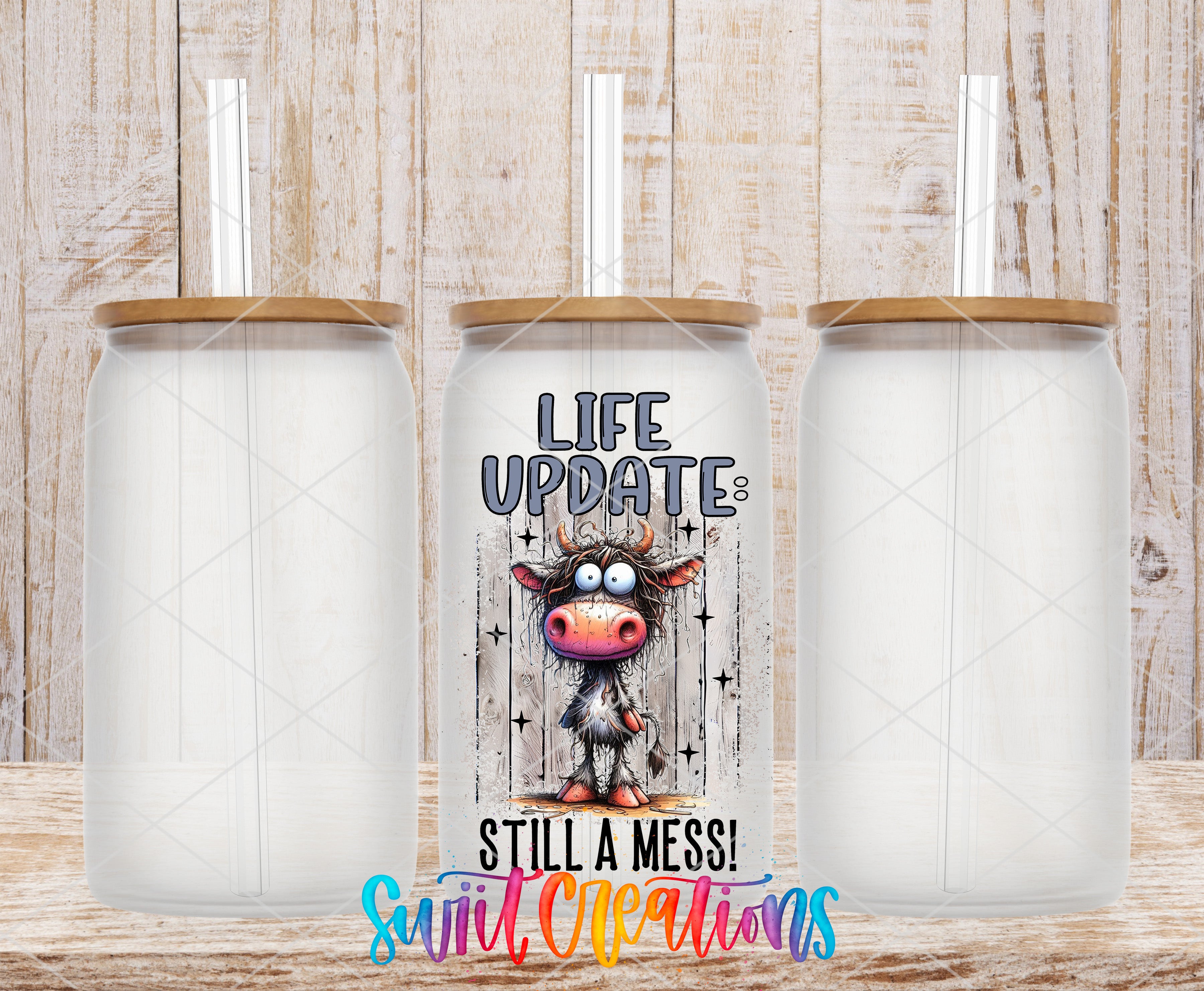 Swiit Creations UV DTF Life Update Still a Mess transfer shown on a clear glass can set