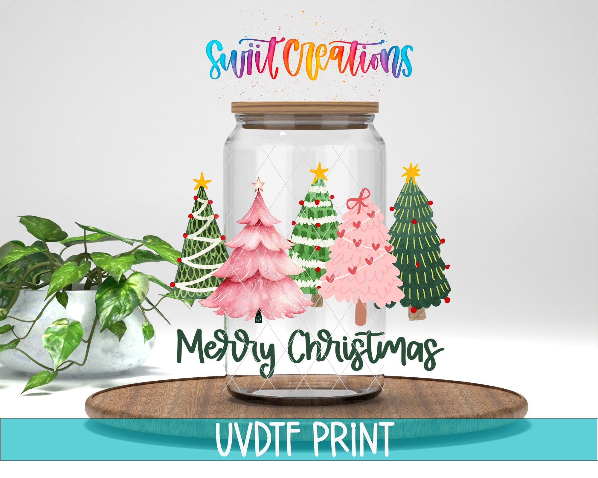 a glass jar filled with christmas trees on top of a wooden table