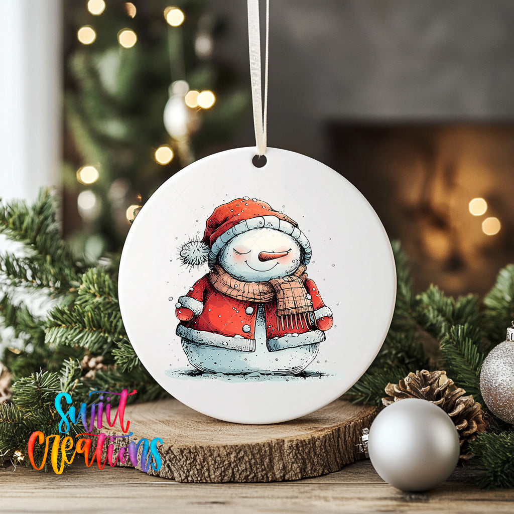 A white ceramic ornament featuring a snowman with a red scarf and hat, sitting on a wooden surface surrounded by Christmas decorations.
