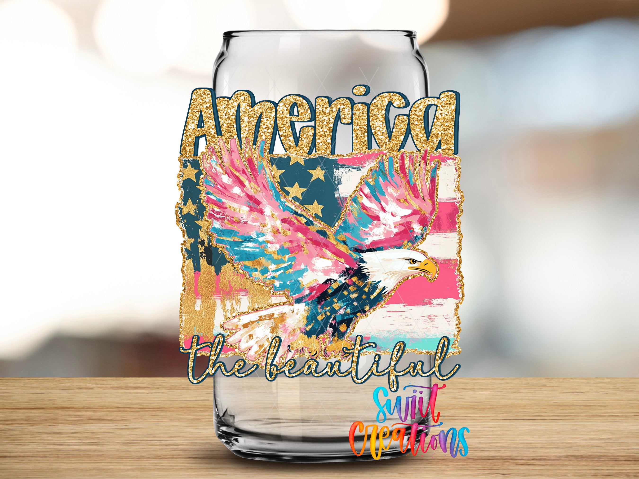 an empty glass can with a colorful design depicting an eagle in flight and the word "America" written on it.
