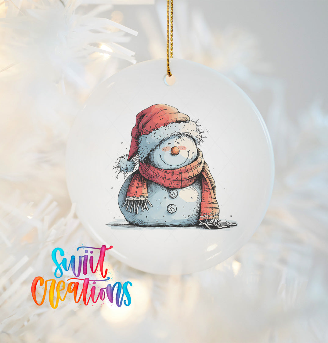 A snowman ornament with a red scarf and hat, sitting on a snowy surface, is hanging on a Christmas tree.