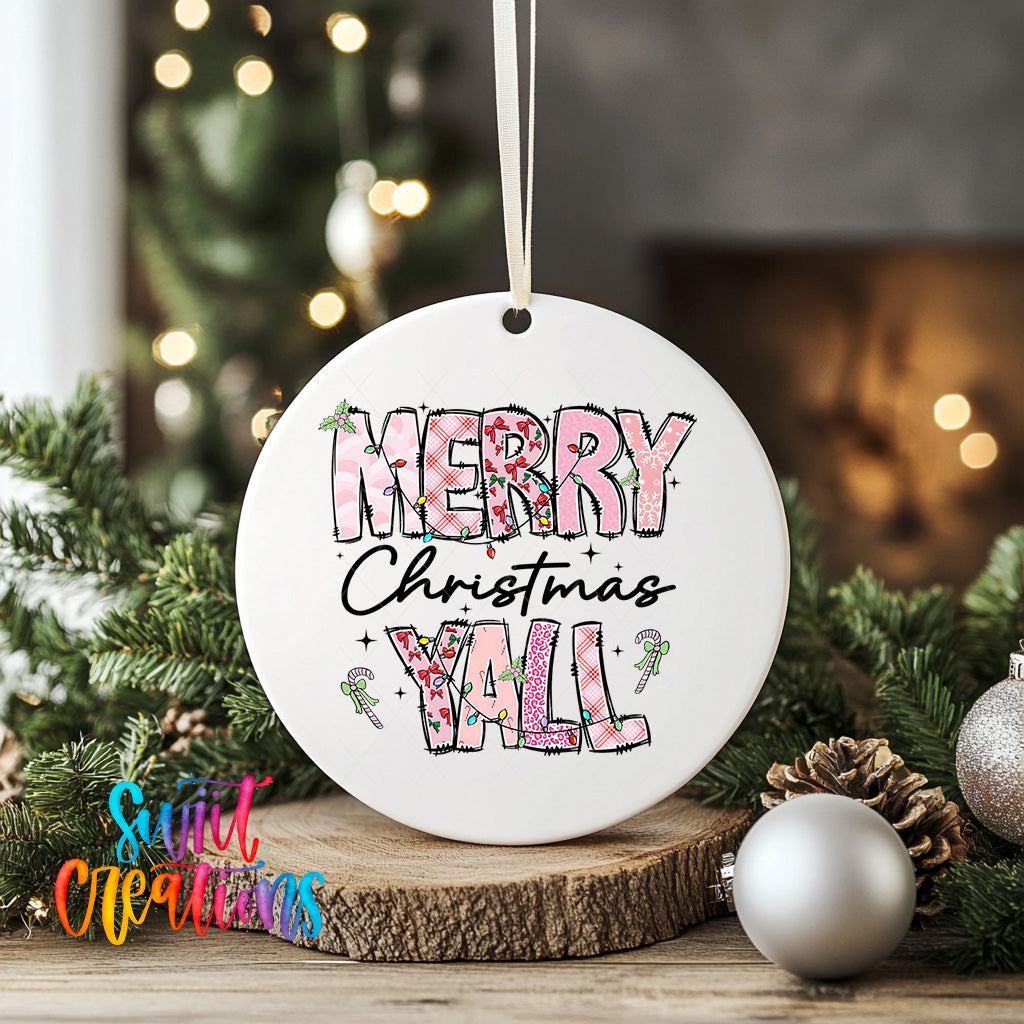 A white ceramic ornament with the text "MERRY CHRISTMAS YALL" printed on it, surrounded by Christmas decorations such as pine branches and ornaments.