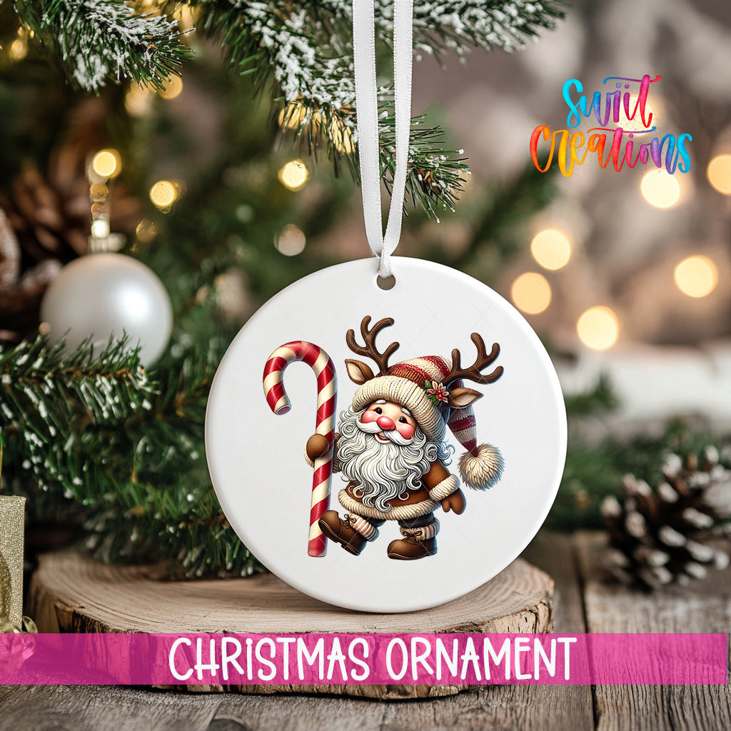 A white Christmas ornament featuring a Santa Claus figure holding a candy cane, hanging on a tree branch with a ribbon.