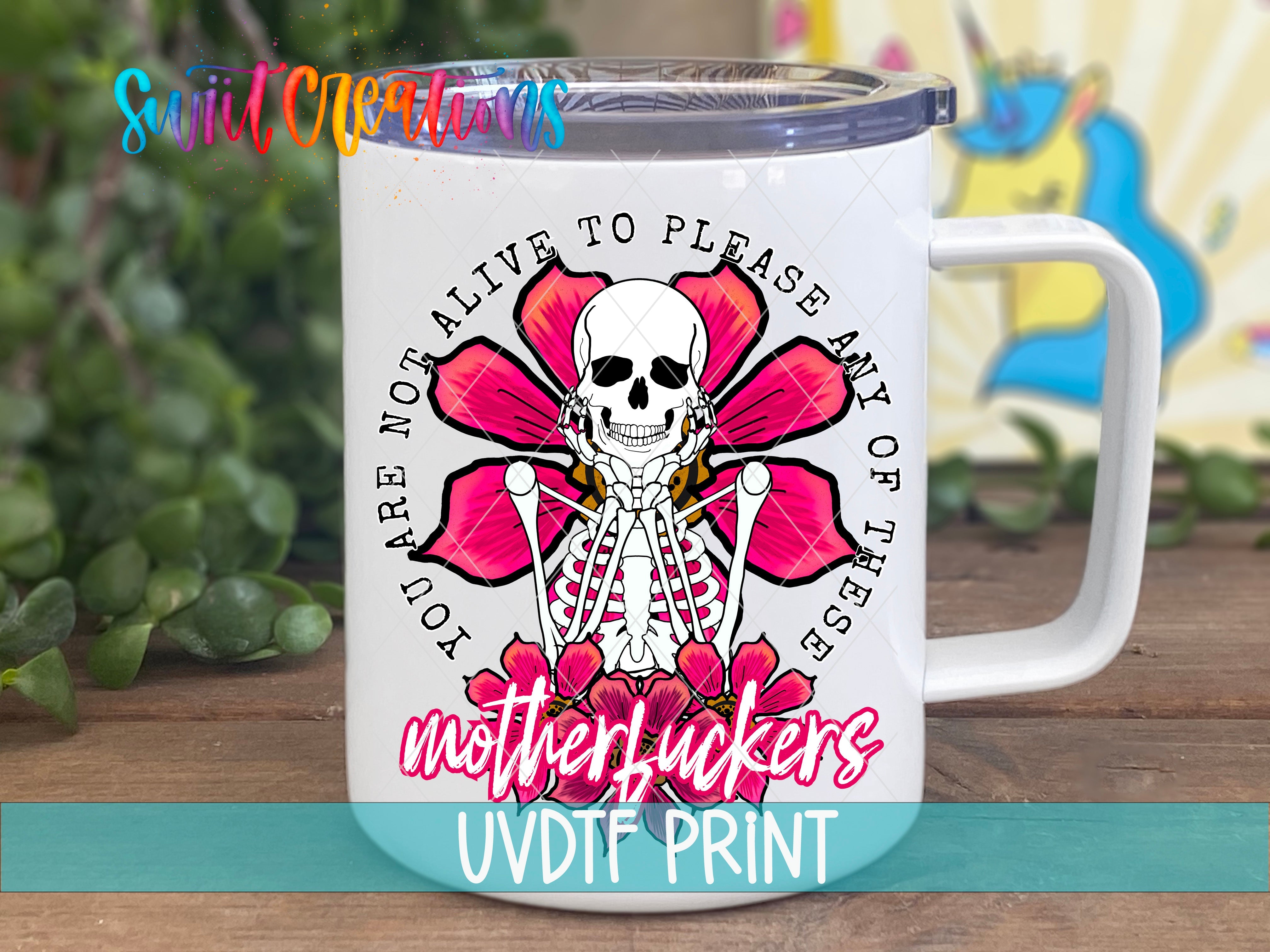 a white coffee mug with a pink flower and a skeleton on it