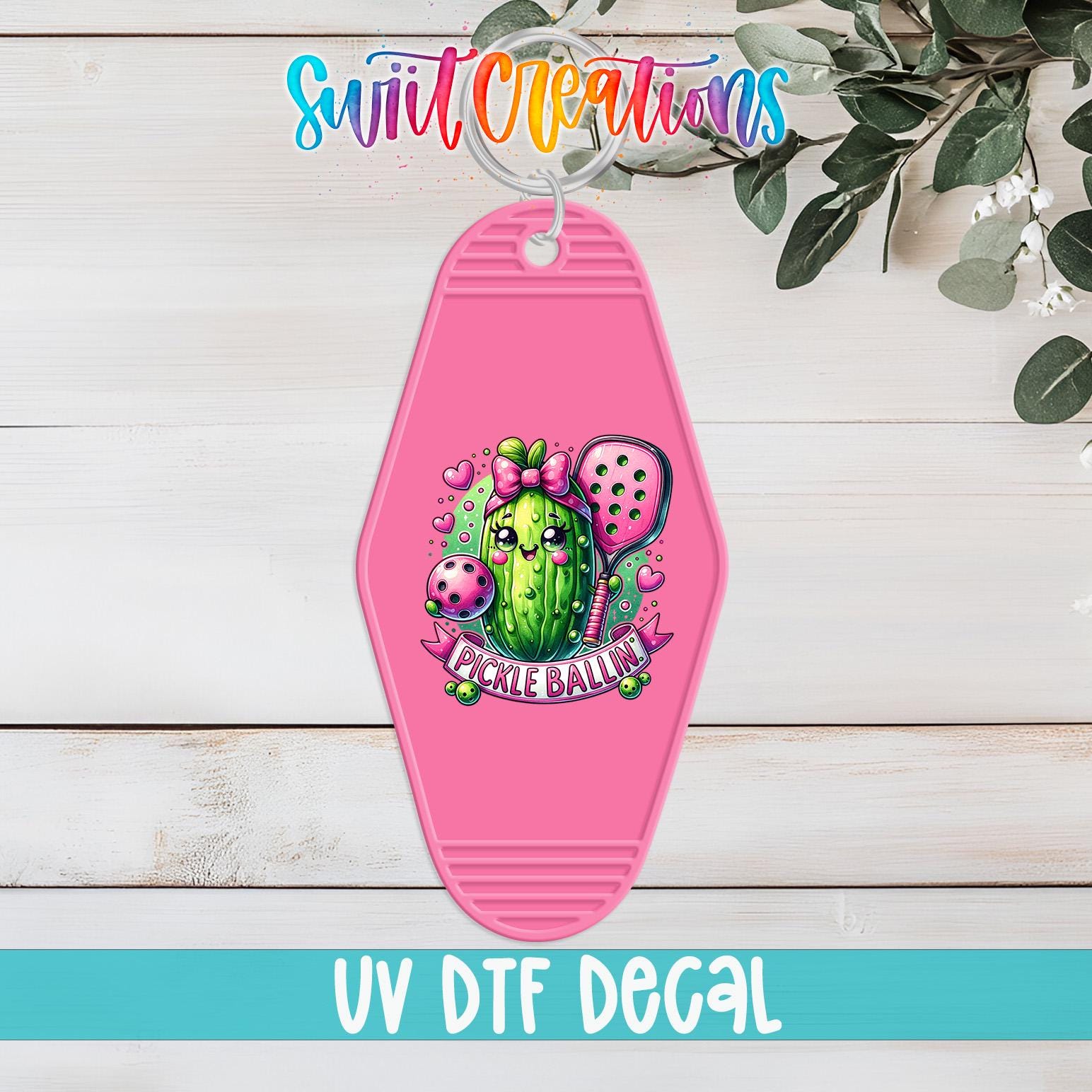 A pink keychain with a cartoon image of a pickle ball and the text "Pickle Ballin'" printed on it, along with a colorful logo and the text "Swit Creations" and "UV Dtf Decal" below it.