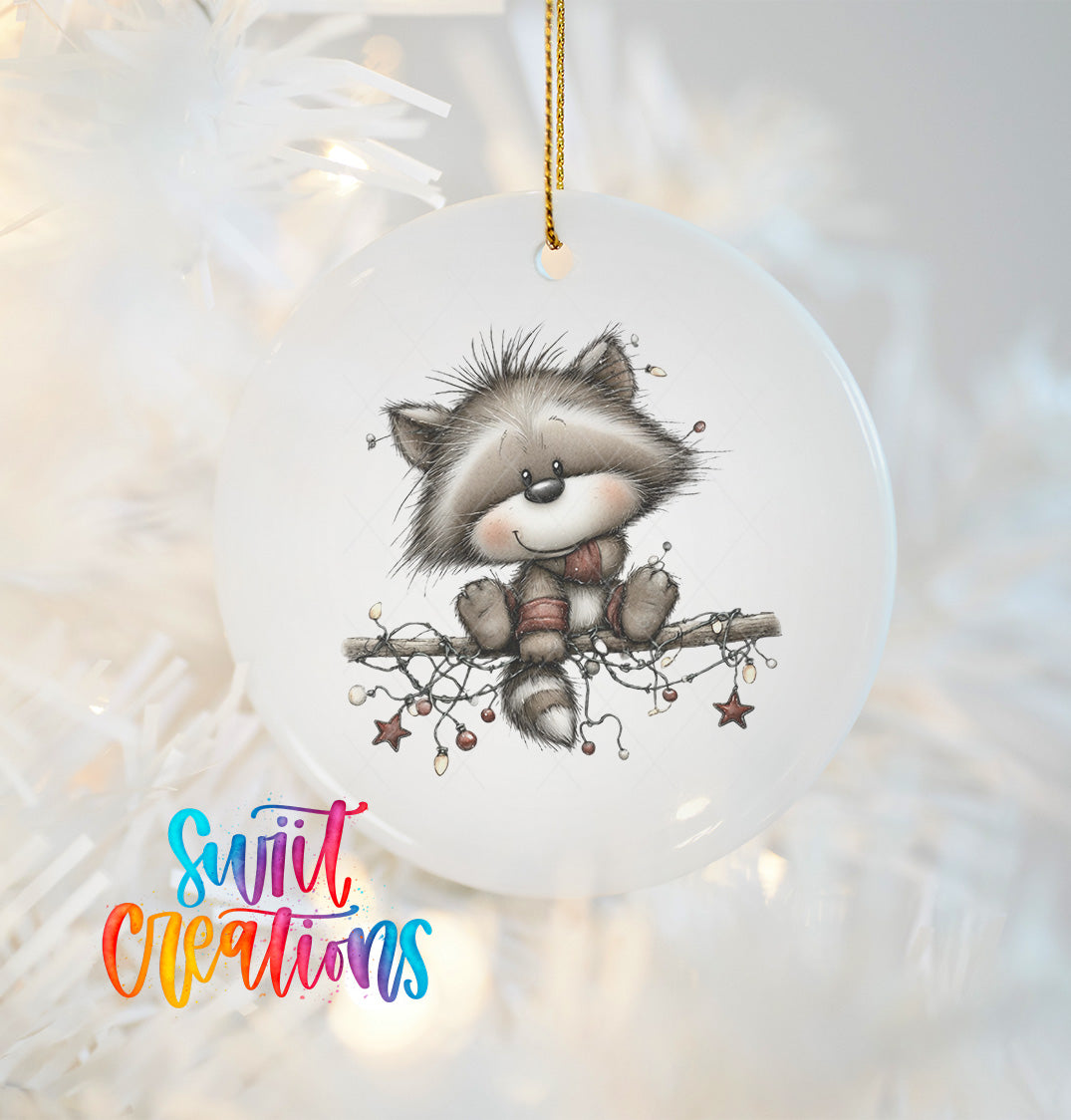A white ceramic ornament featuring a cute raccoon sitting on a branch with lights and stars.