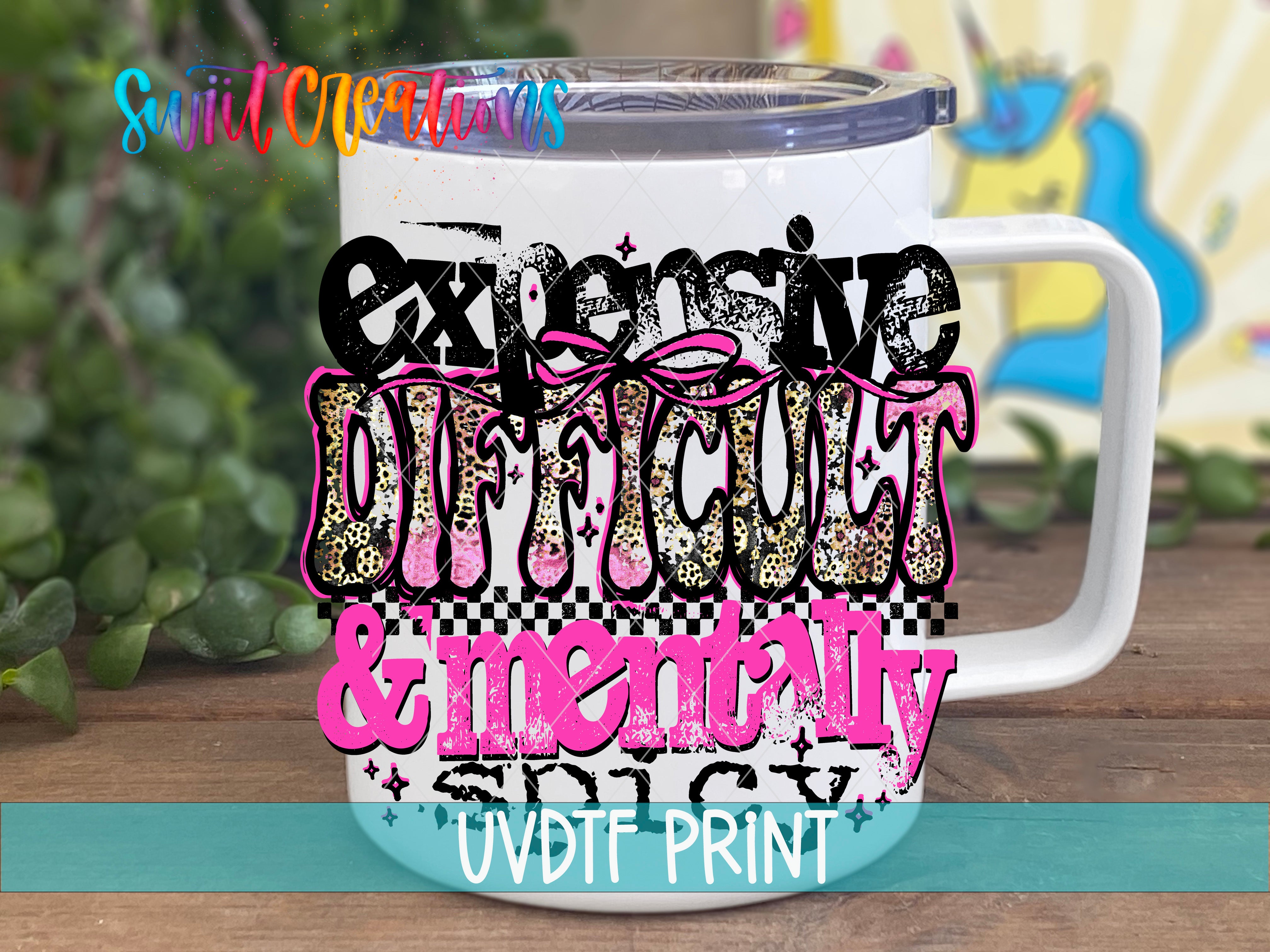 A white mug with a colorful, artistic design featuring the text "Expensive, Difficult & Mentally Spicy" in a stylized font.