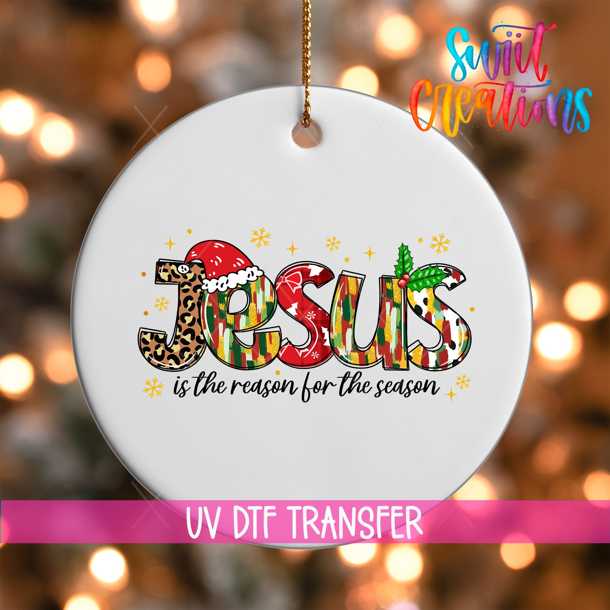 A white ceramic ornament with the word "JESUS" written in a colorful, stylized font.