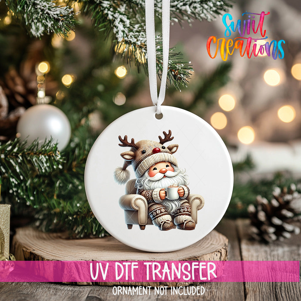 A white ornament with a Santa Claus reindeer sitting in a chair, surrounded by Christmas decorations and lights.