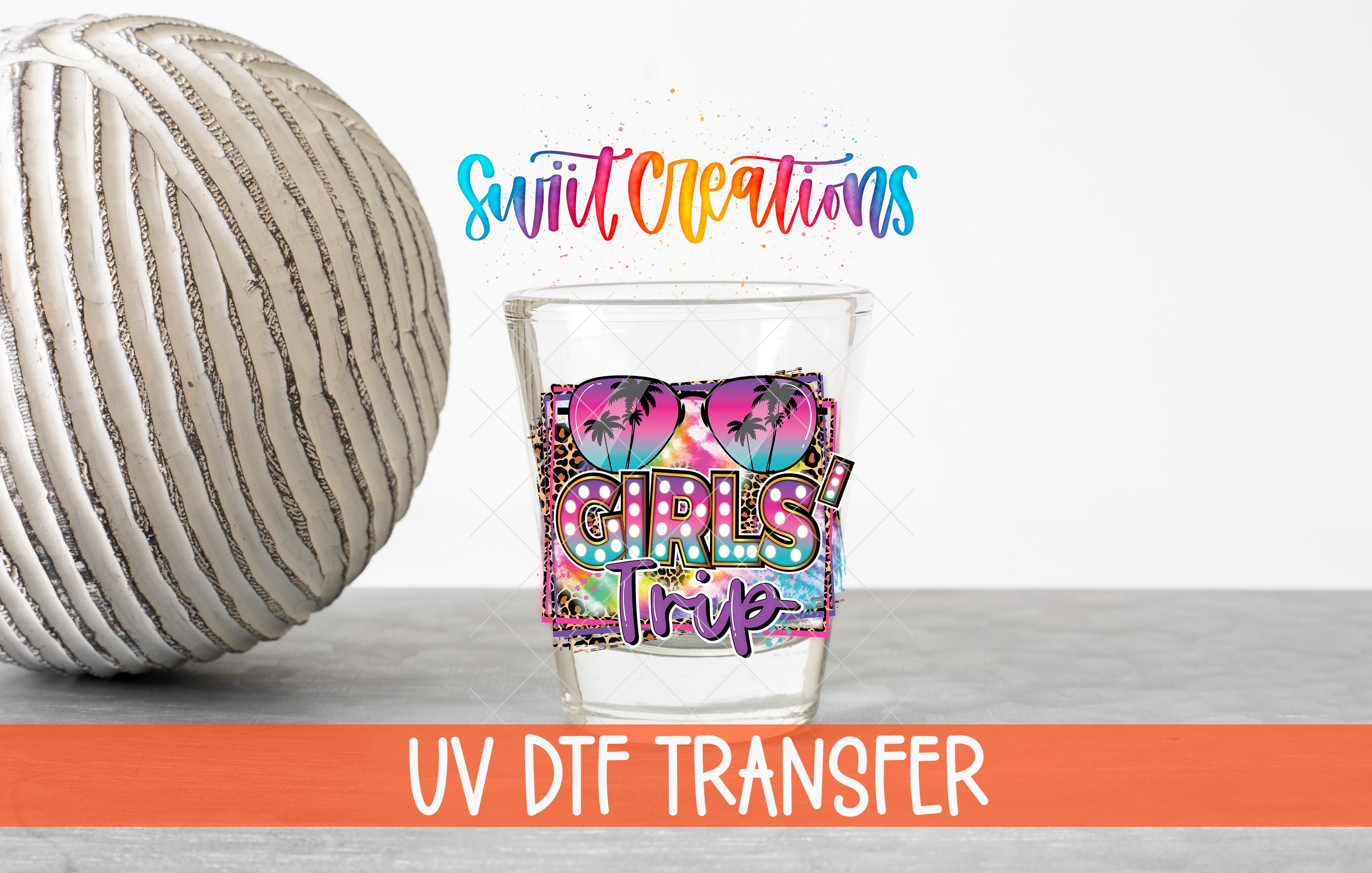a glass with a colorful design, a white ball, and text related to UV dye transfer.