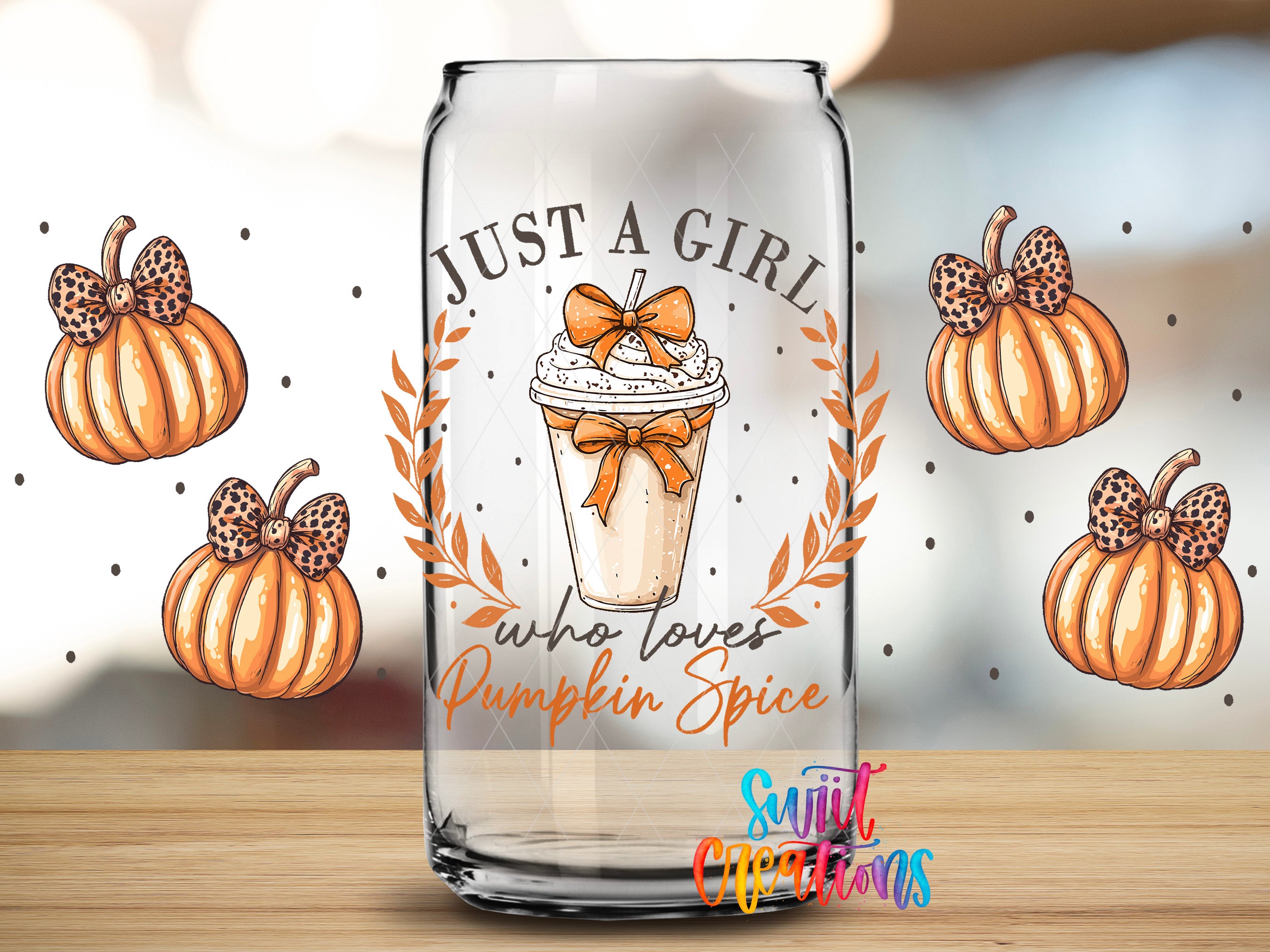 A glass can with a pumpkin-themed design and text, surrounded by leopard print bows and pumpkins.