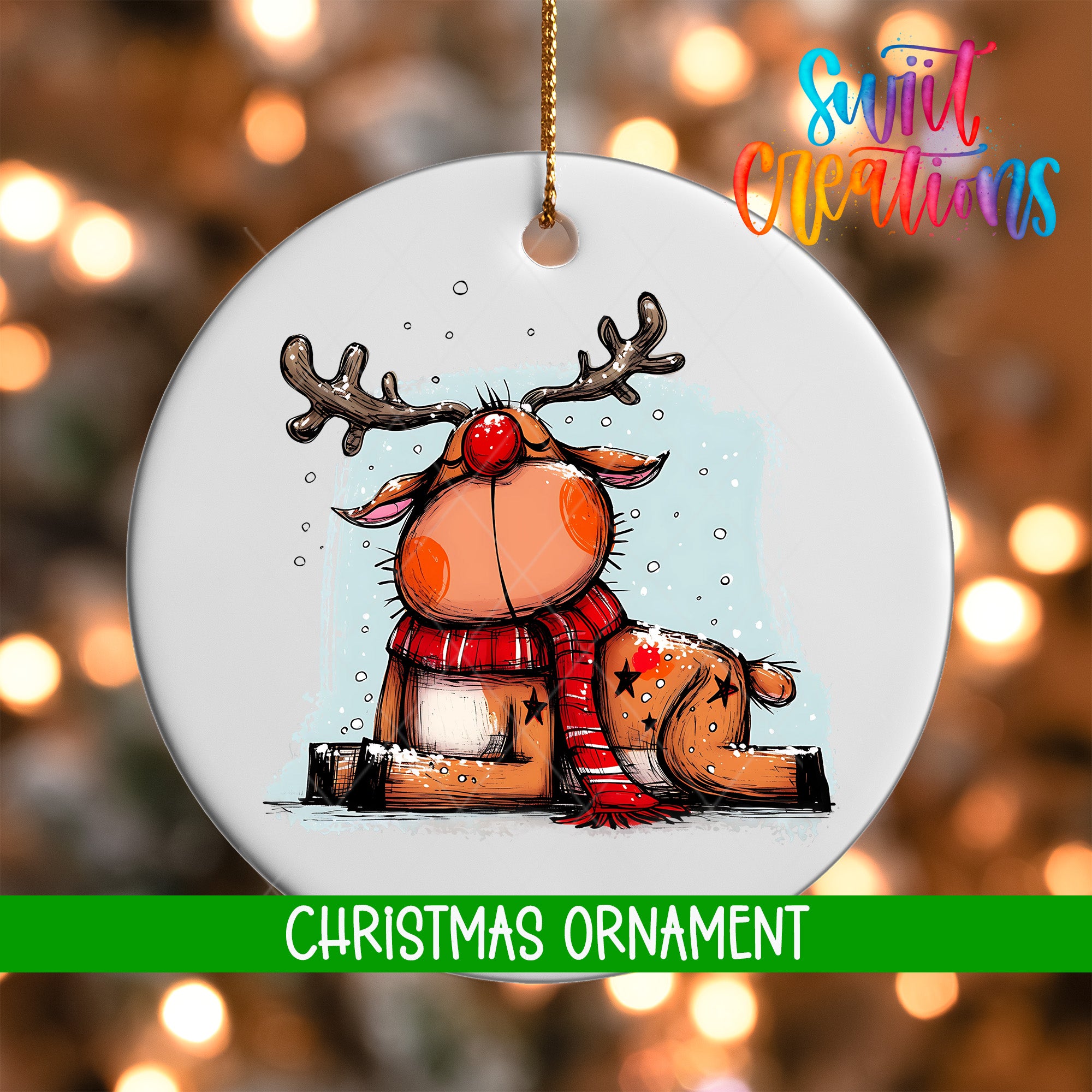 A white Christmas ornament featuring a cartoon reindeer with antlers and a red nose, sitting on a snowy surface.