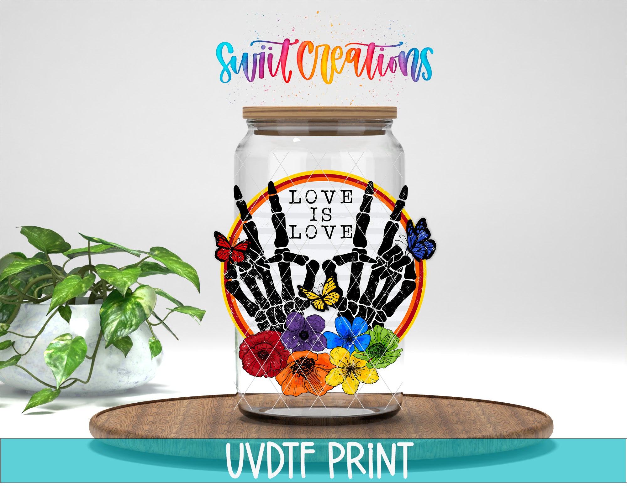 a glass jar with a colorful design, including a skeleton hand, flowers, and butterflies. The text "Love is love" is displayed on the jar, and the phrase "Swift Creations" is written above it. The jar is placed on a wooden surface, and there is a potted plant in the background.