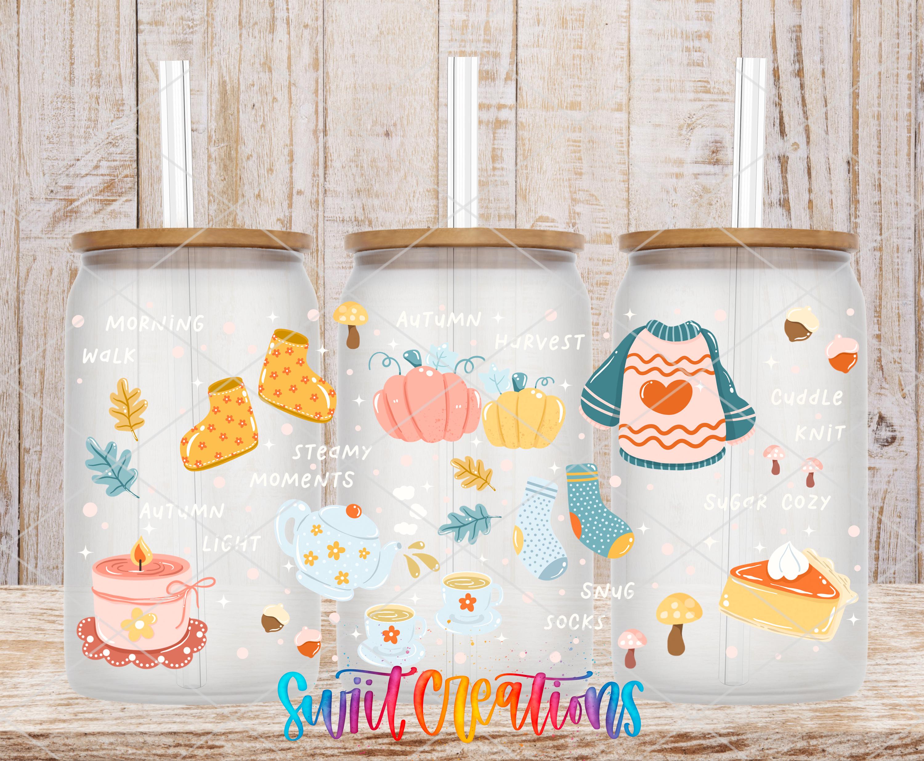 A collection of three glass jars with straws, each containing illustrations related to autumn and winter themes. The jars feature various seasonal objects such as pumpkins, leaves, and a pie.
