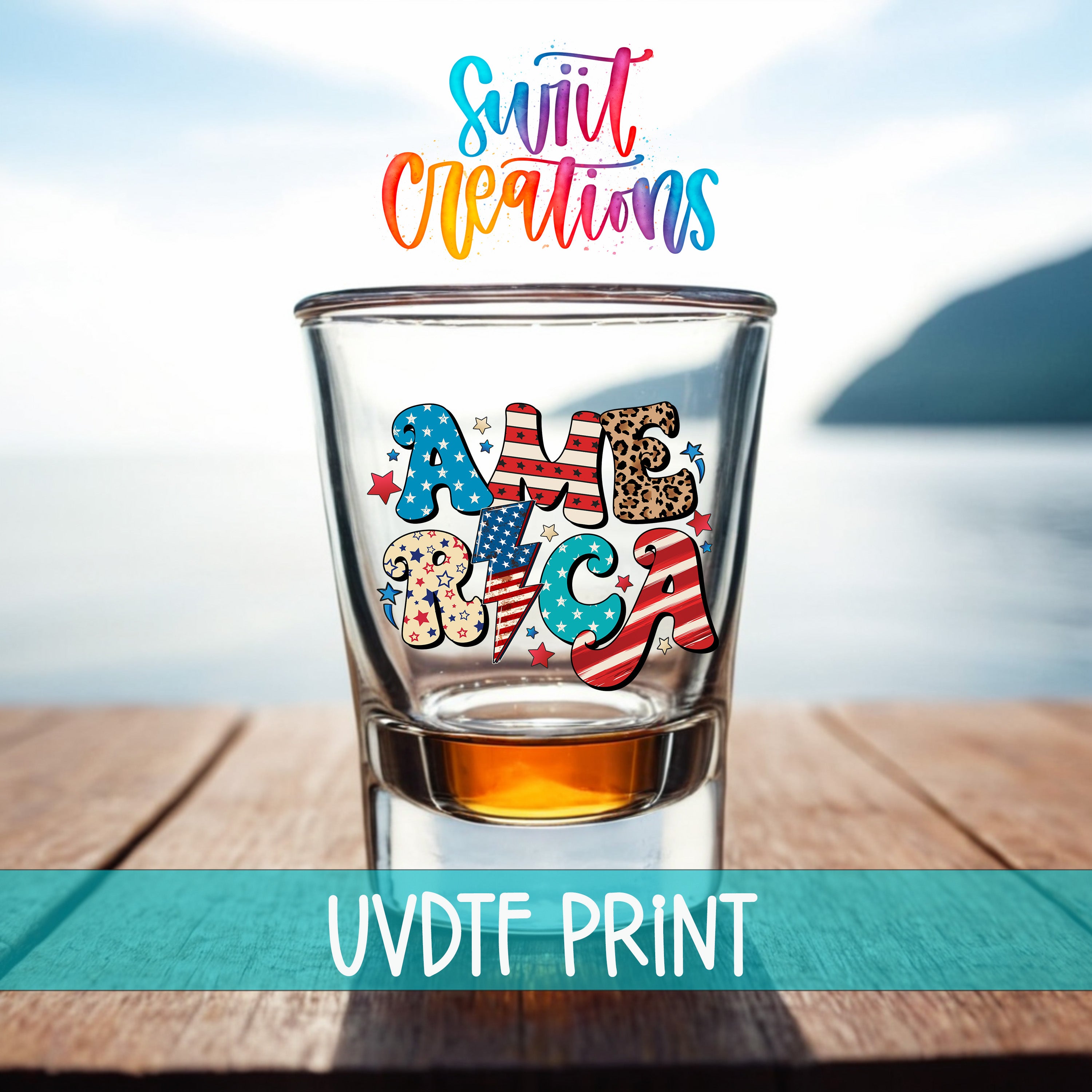 a shot glass with the word "AMERICA" printed on it, placed on a wooden surface with a body of water in the background.