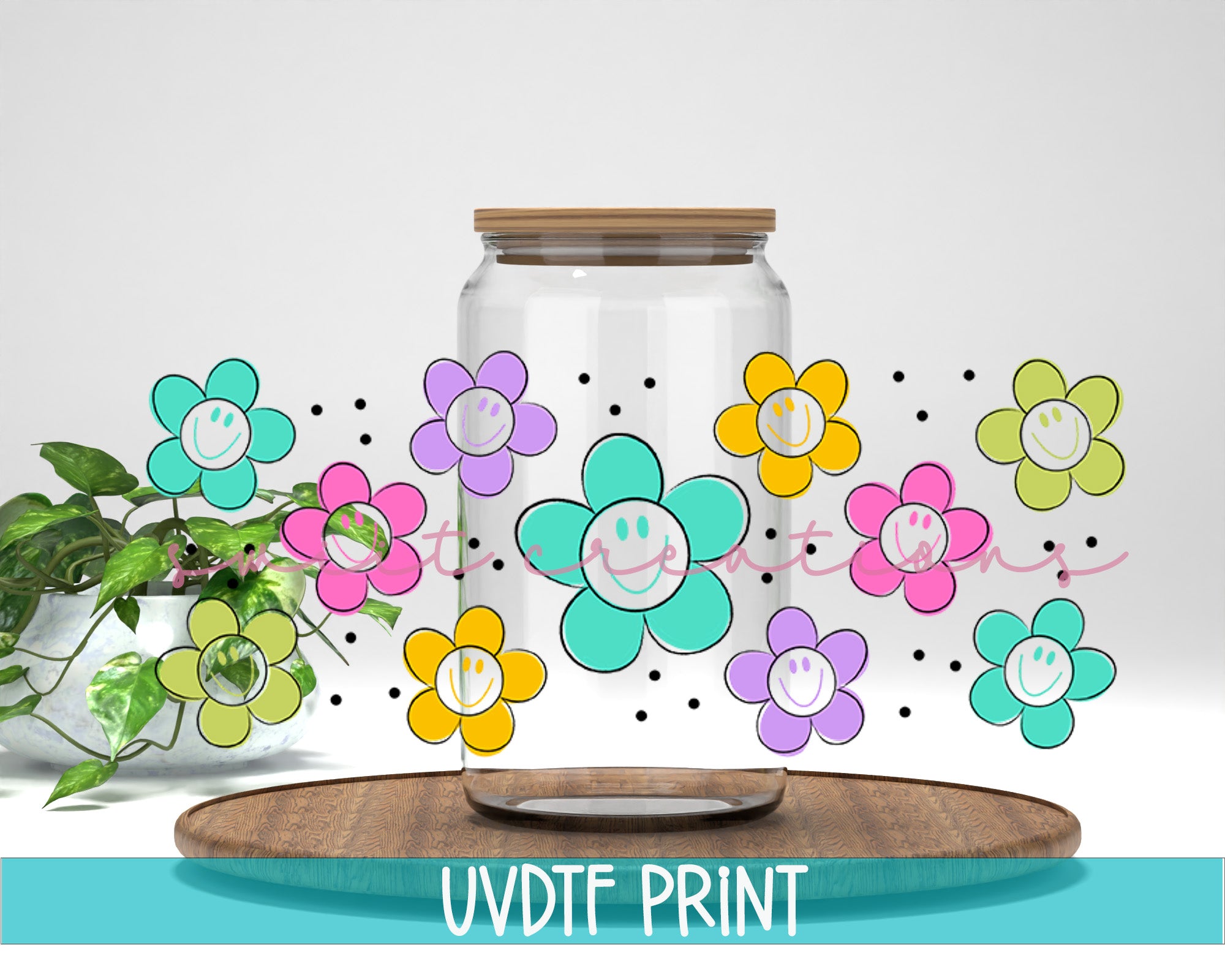 a vase with flowers painted on it next to a plant