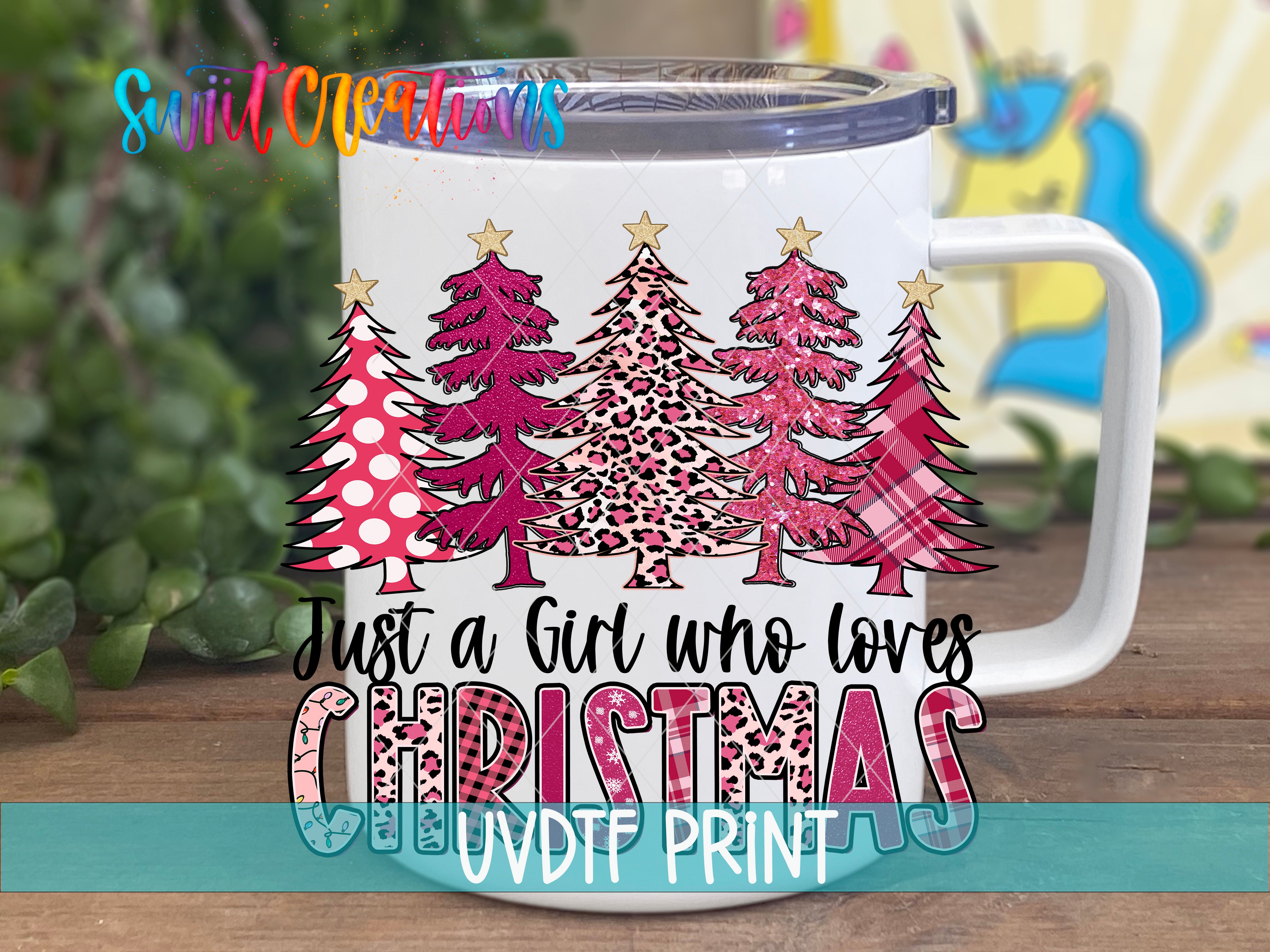 A white mug with a Christmas tree design and text printed on it.