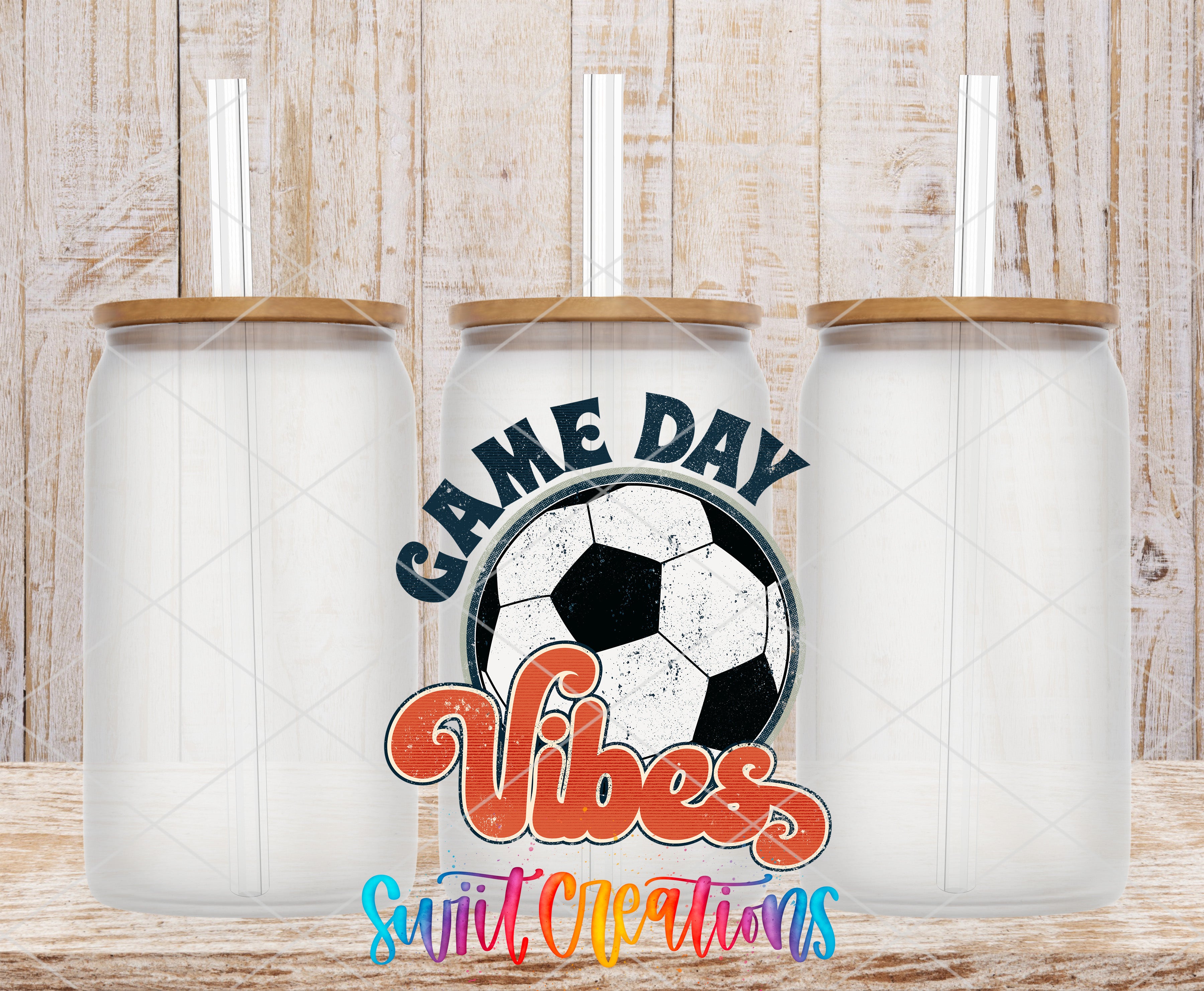 Three clear glass cans with the Soccer Game Day Vibes UV DTF transfer by Swiit Creations