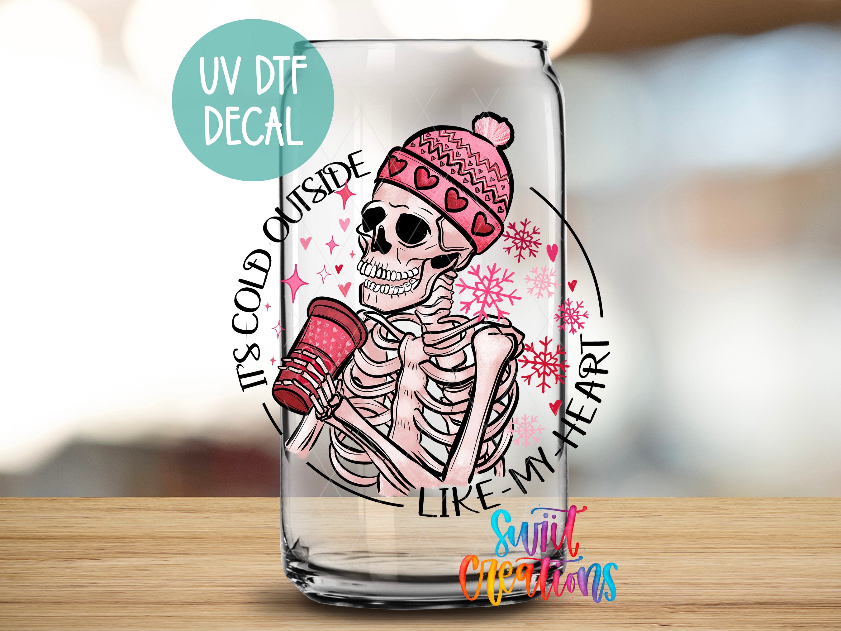 a glass with a skeleton holding a cup