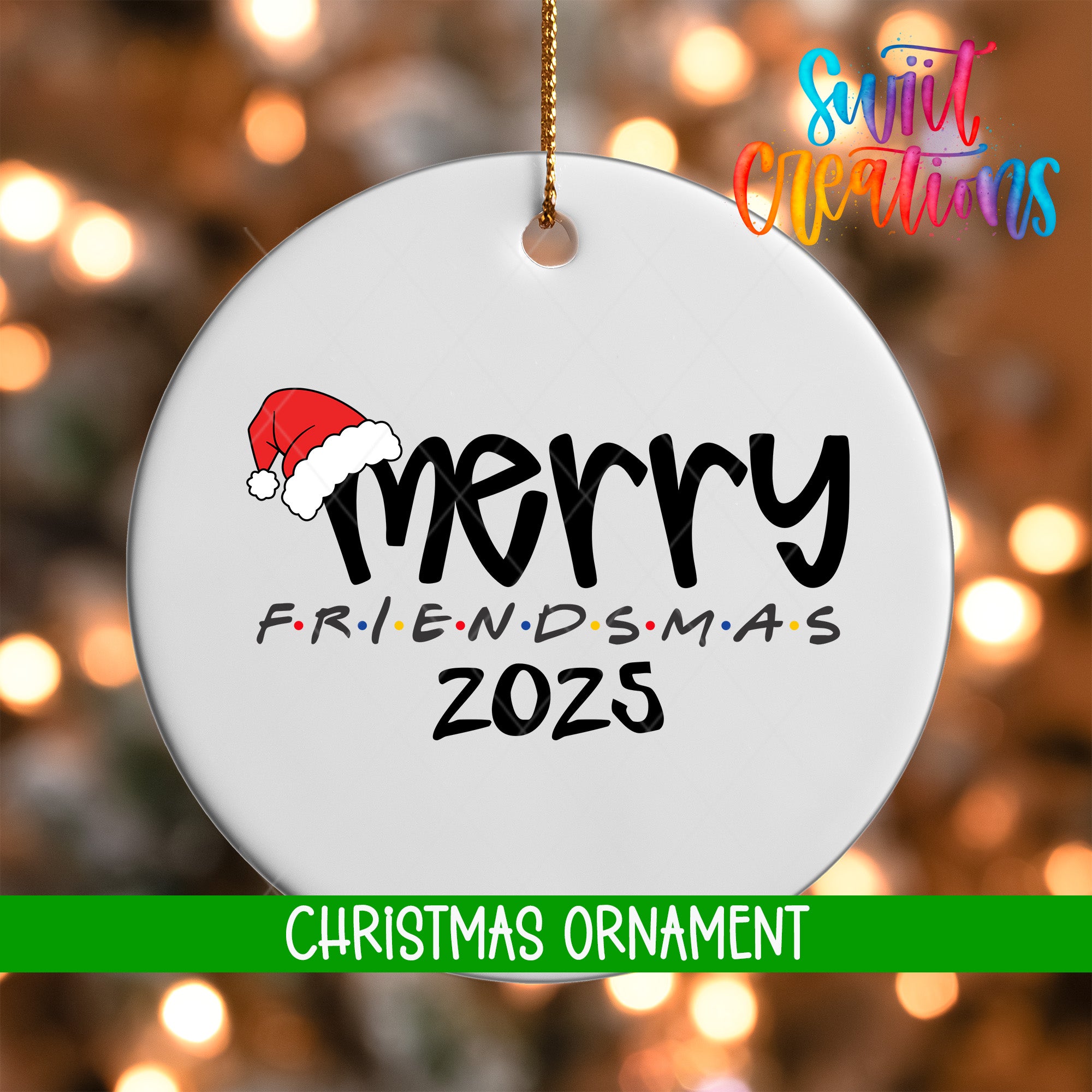 A white Christmas ornament with the text "MERRY FRIENDS M.A.S. 2025" printed on it, along with a Santa hat icon.