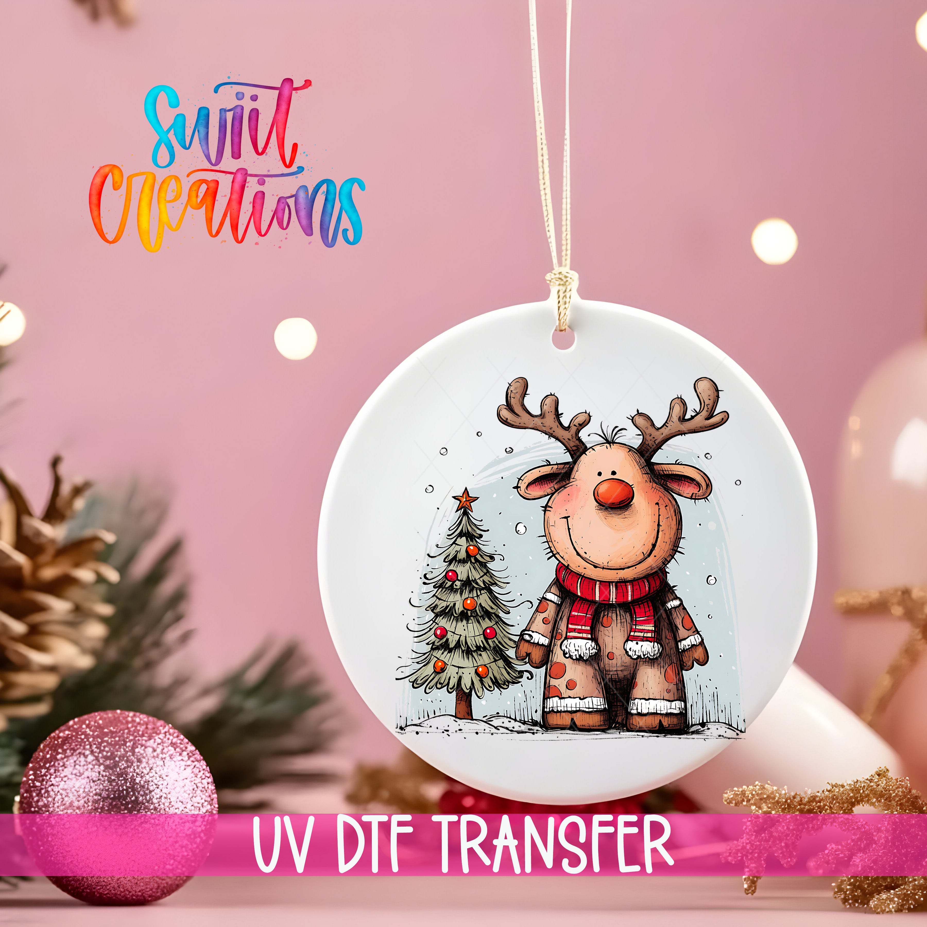 A white ceramic ornament featuring a cartoon reindeer and a Christmas tree, hanging on a string against a pink background with Christmas decorations in the background.