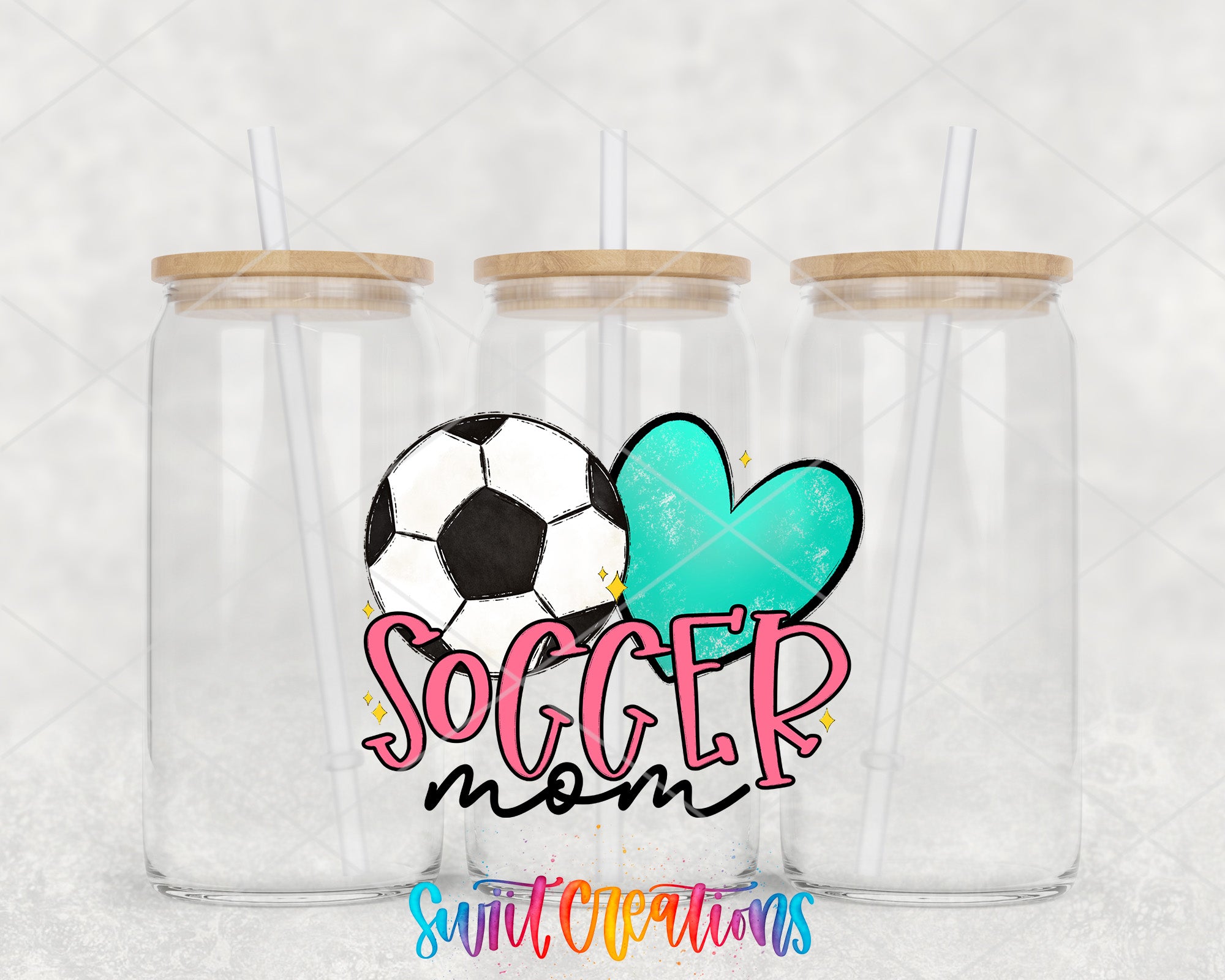 three clear glass jars with wooden lids, each with a straw, arranged in a row. The jars are labeled "Soccer mom" in a stylized font, and there is a soccer ball and a heart-shaped design in the center of the jars.