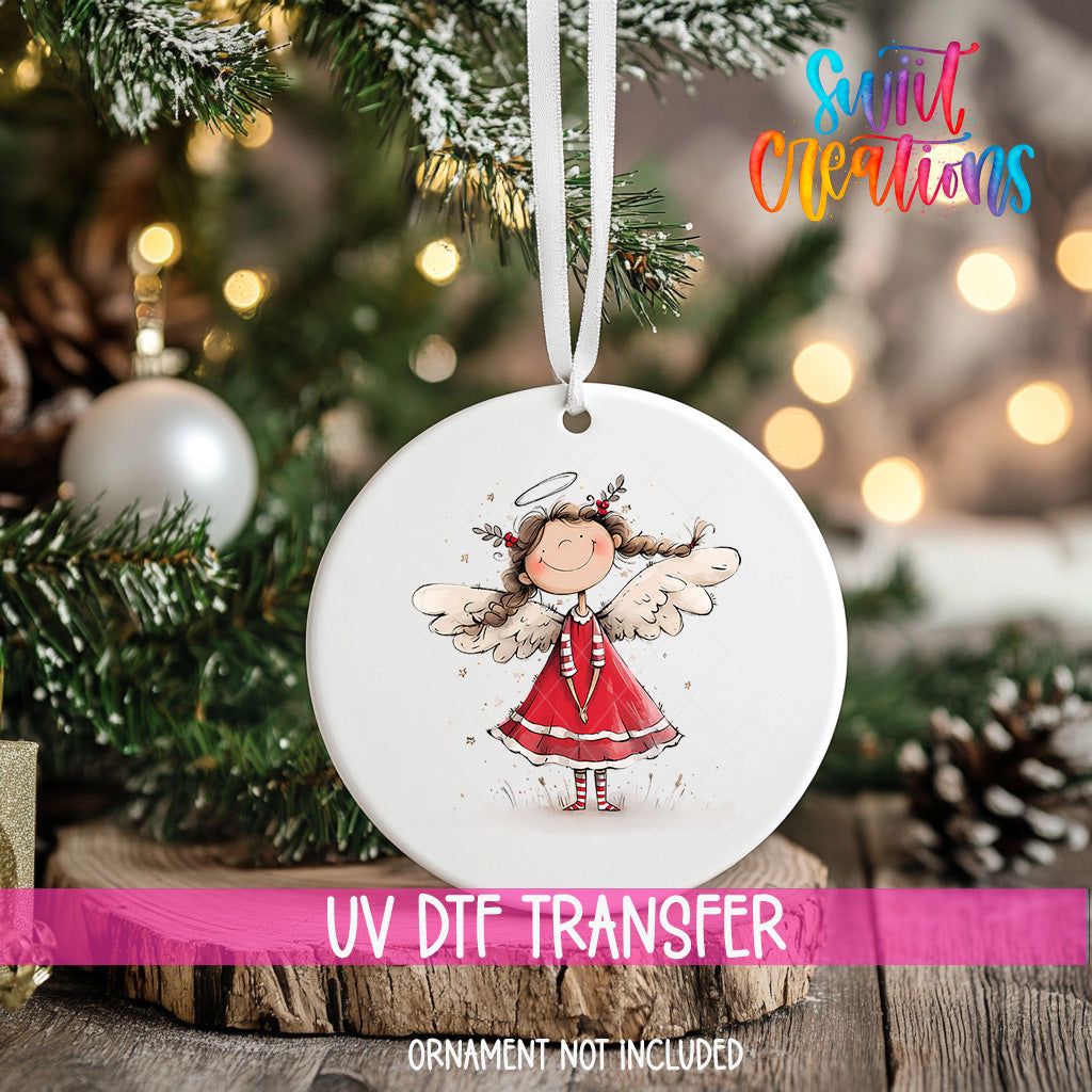 A white ceramic ornament with a smiling angel figure is hanging on a Christmas tree, with a blurred background of pine branches and twinkling lights.