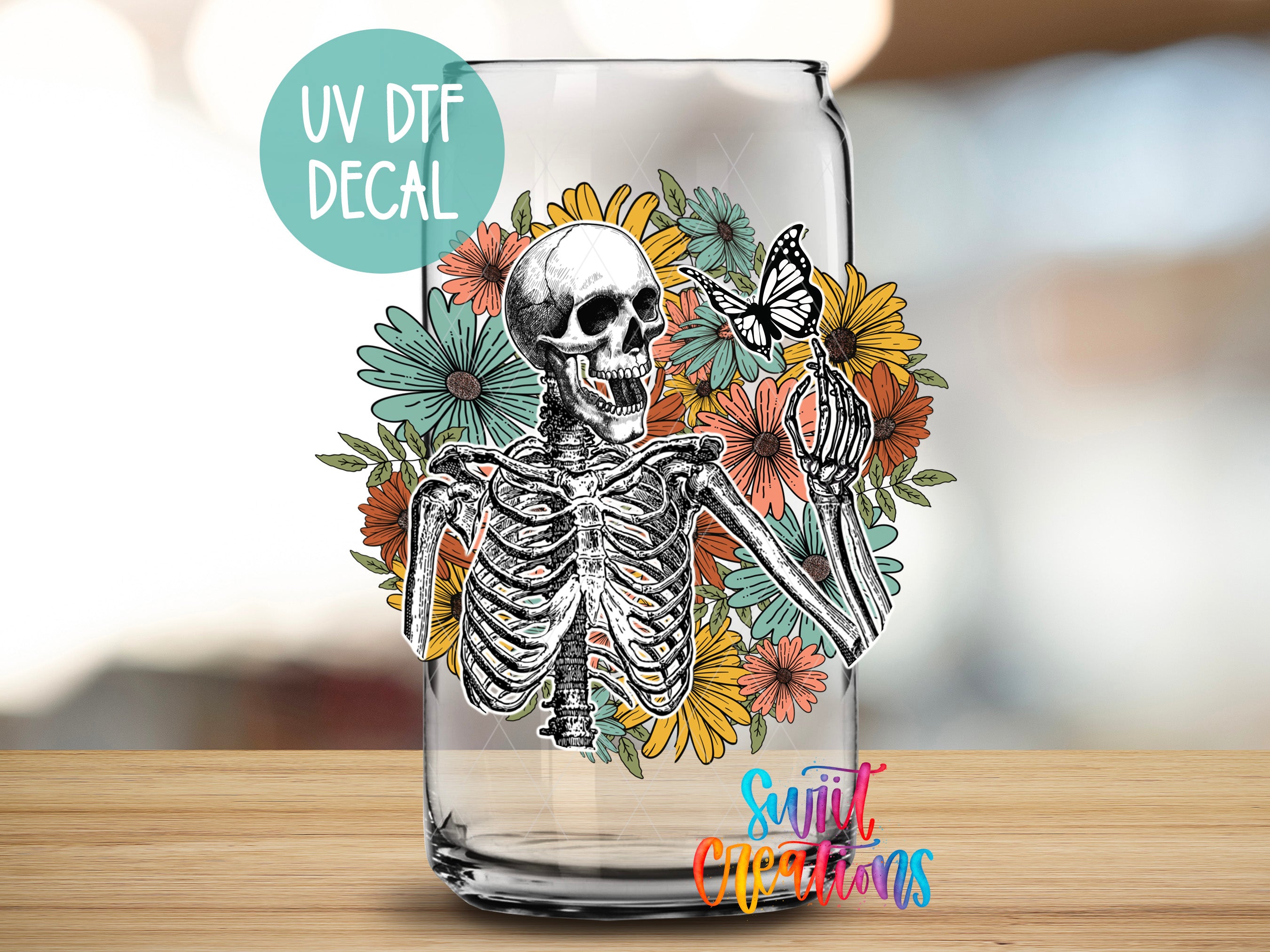 a glass with a skeleton and flowers on it