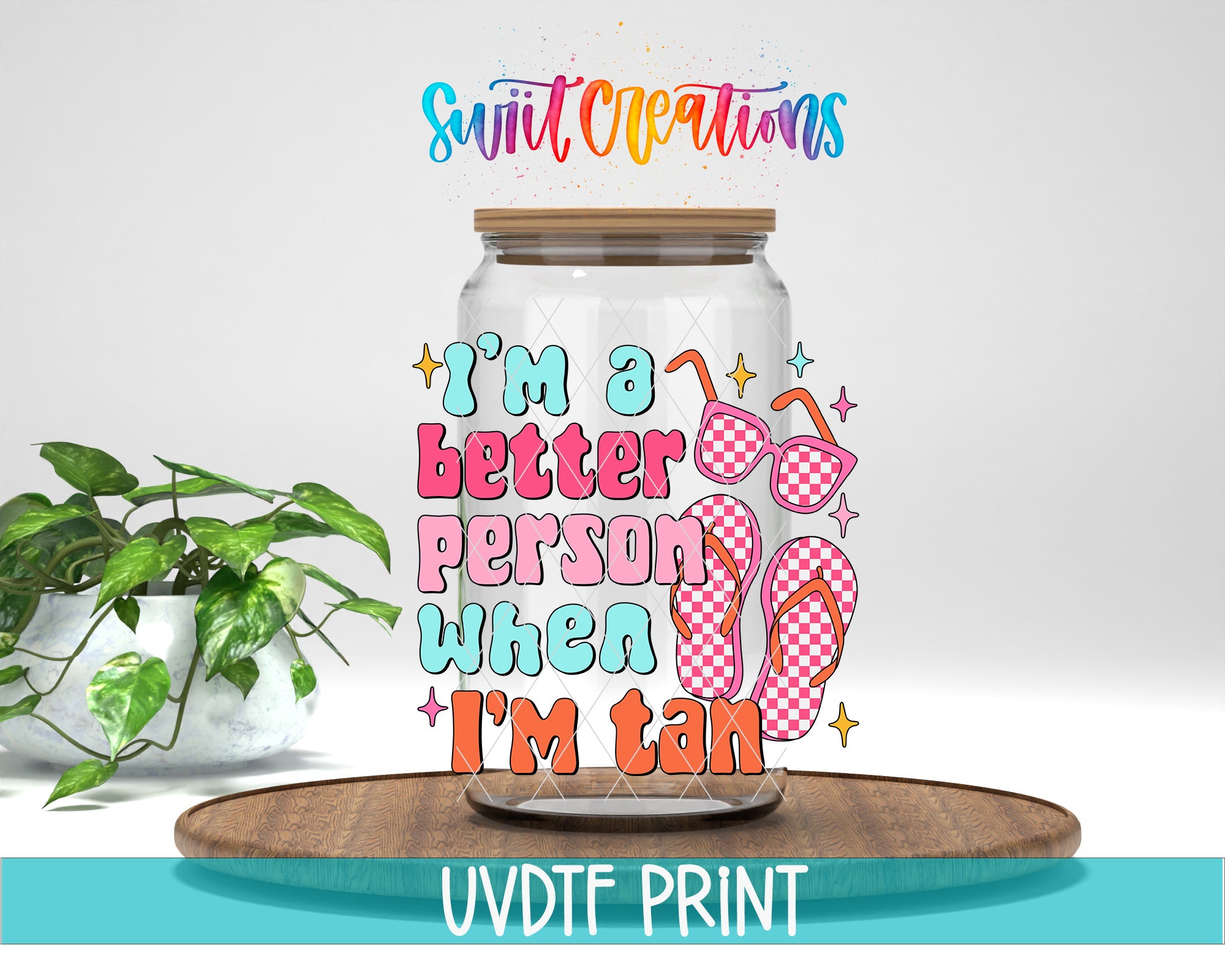 A glass jar with a lid, decorated with colorful text and illustrations, placed on a wooden surface.