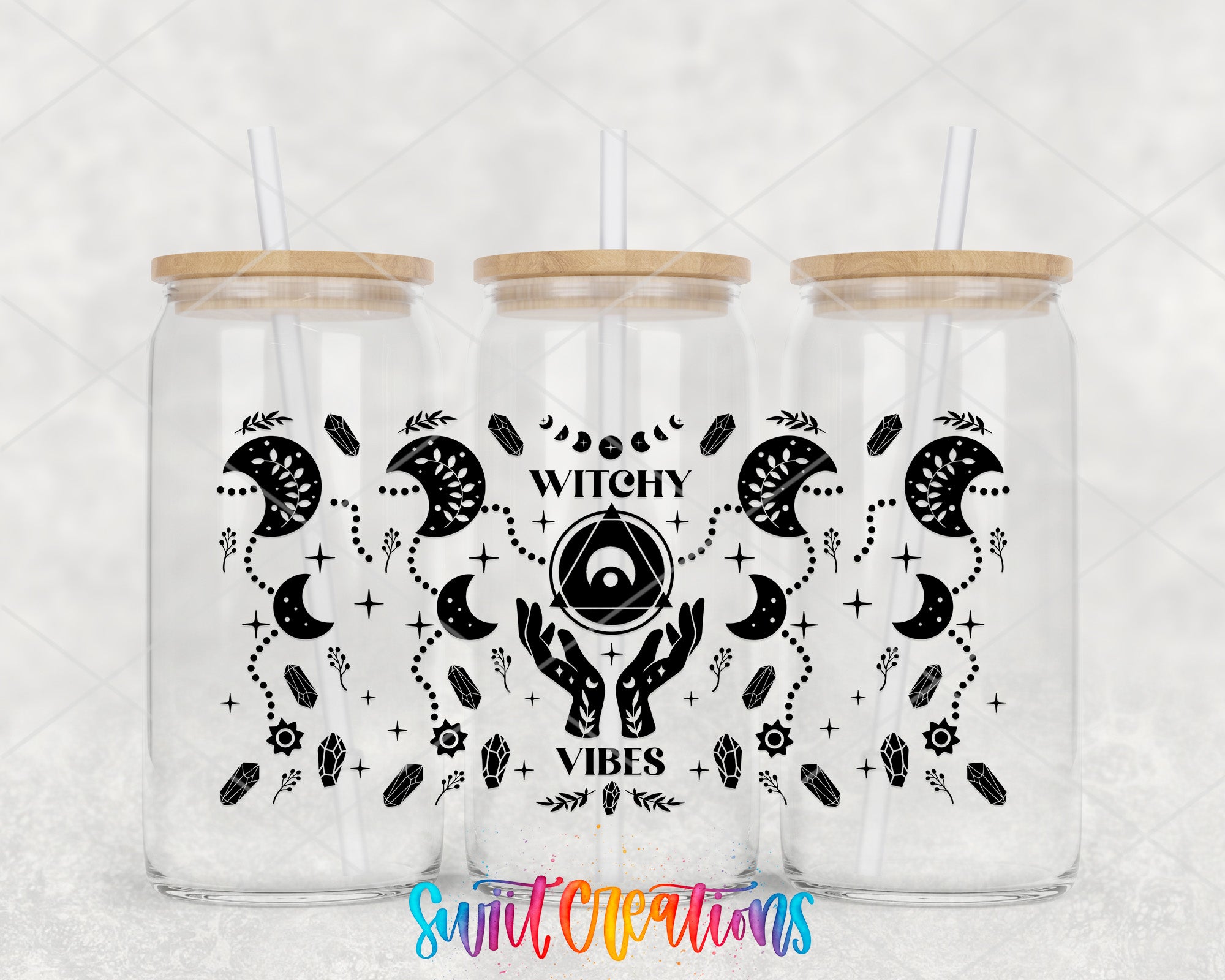 three glass jars with wooden lids, each containing a straw. The jars are decorated with black and white illustrations of celestial objects, such as crescent moons, stars, and planets, along with the text "Witchy Vibes" written in a stylized font.