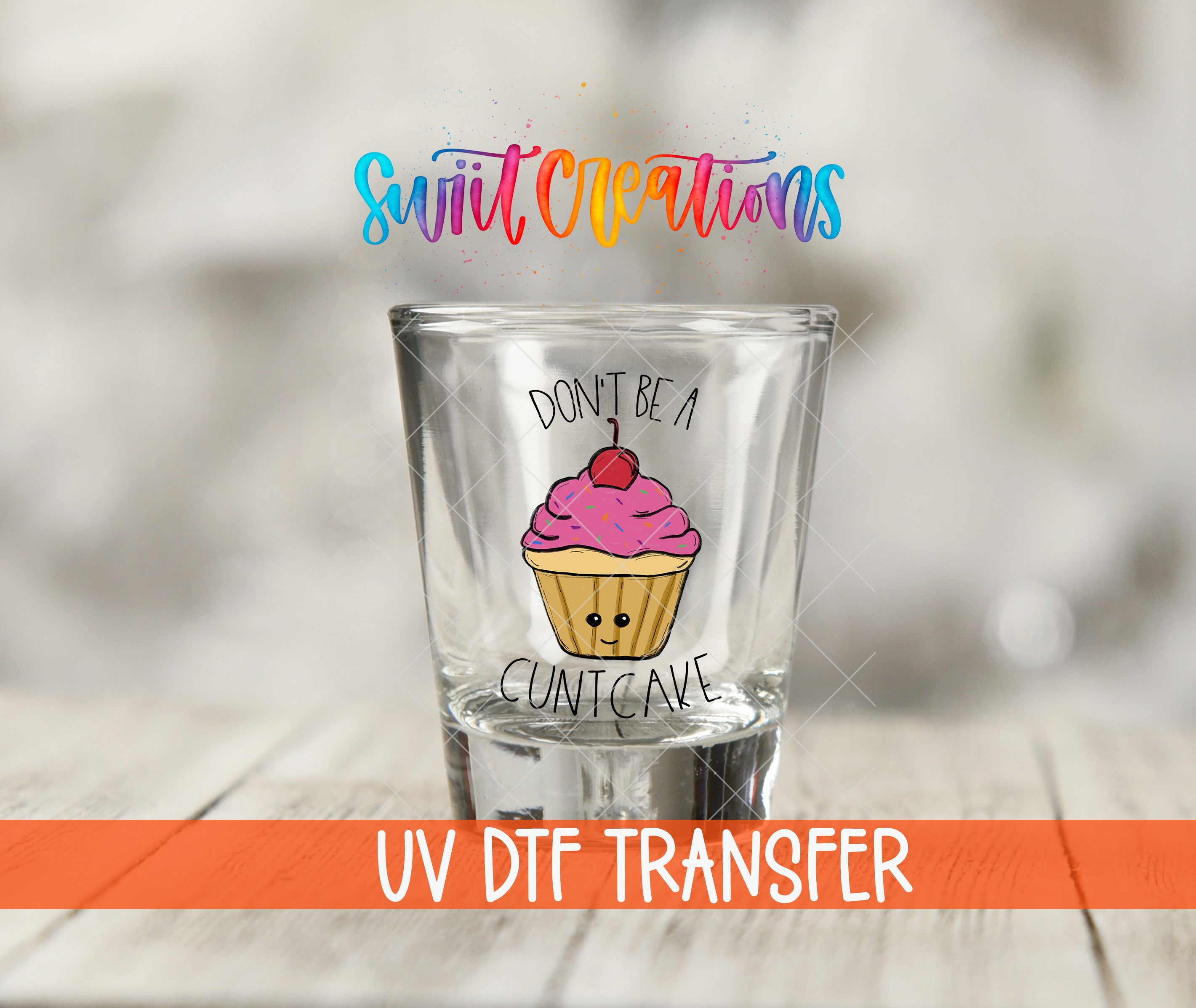 A shot glass with a cupcake design and the text "DON'T BE A CUNTCAVE" printed on it.