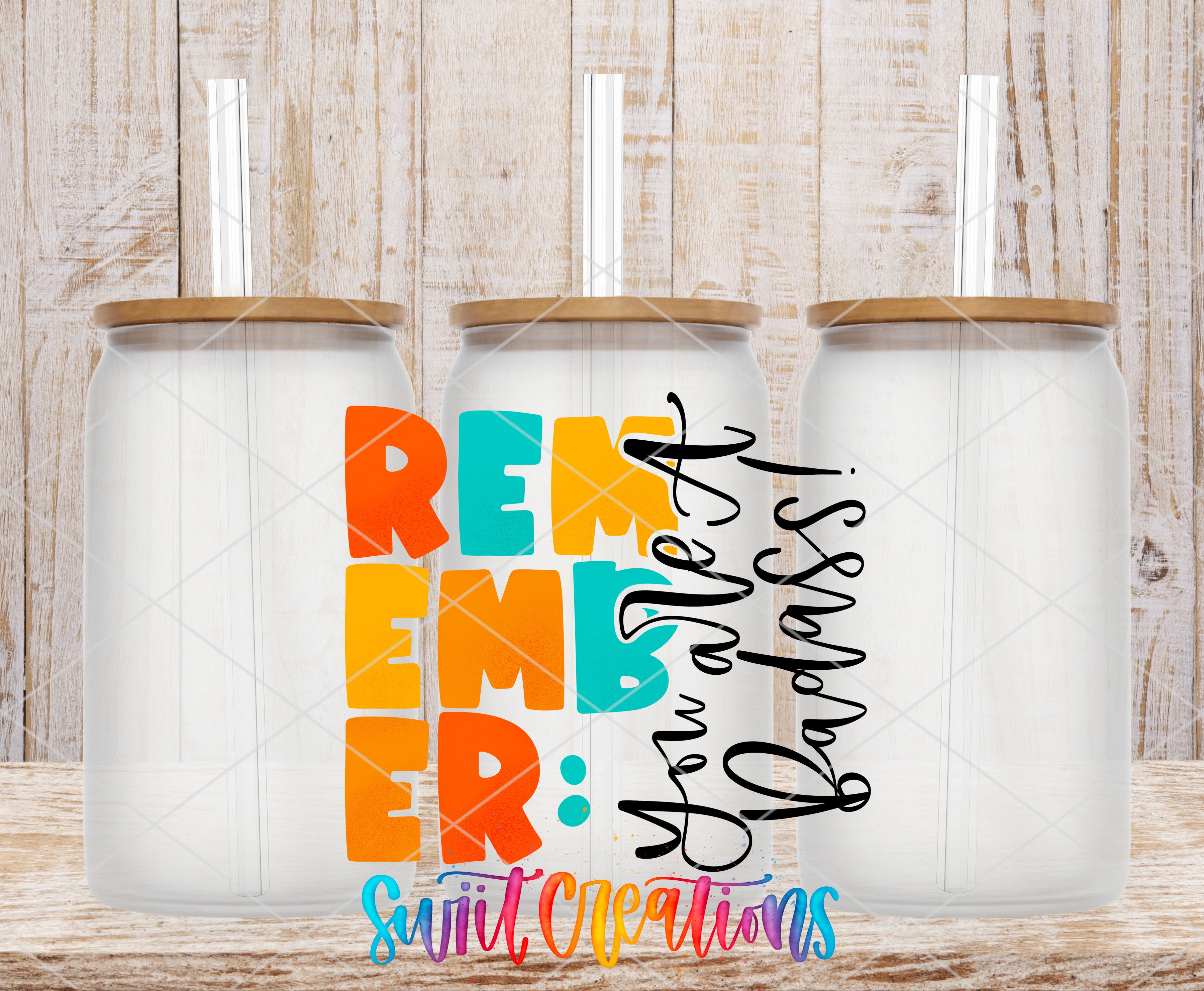Three clear glass cans with the Remember You Are a Badass UV DTF transfer by Swiit Creations
