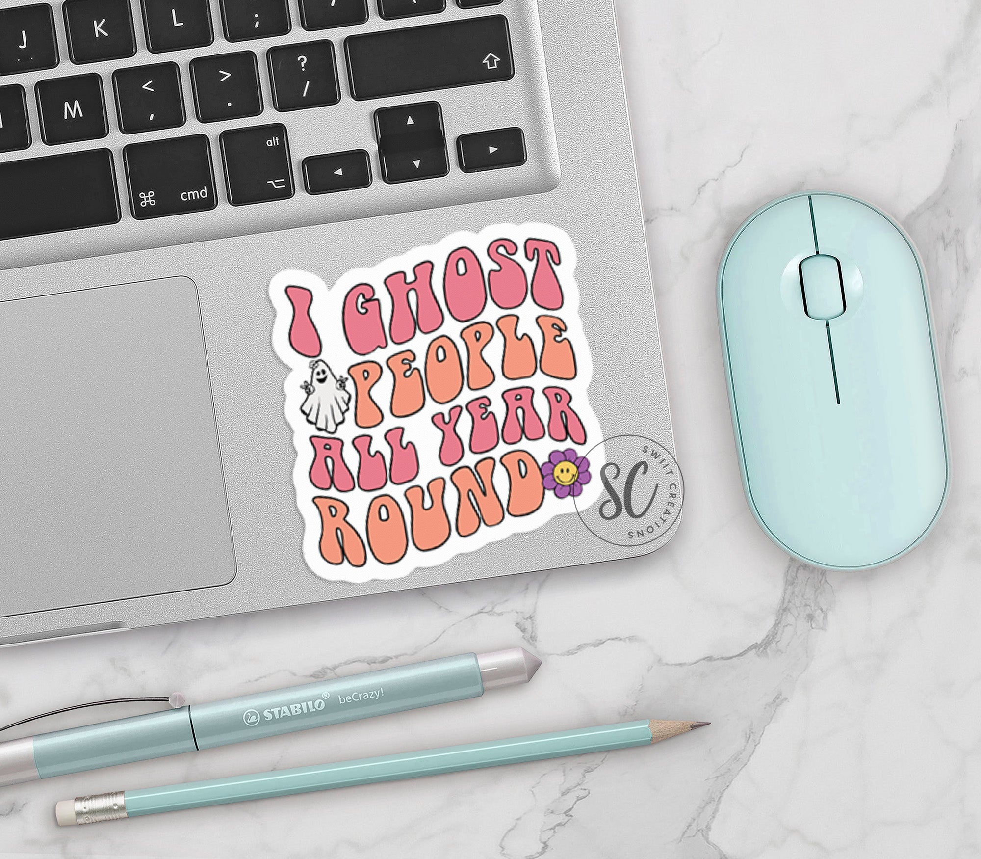 a laptop with a sticker that says i ghost people all year round