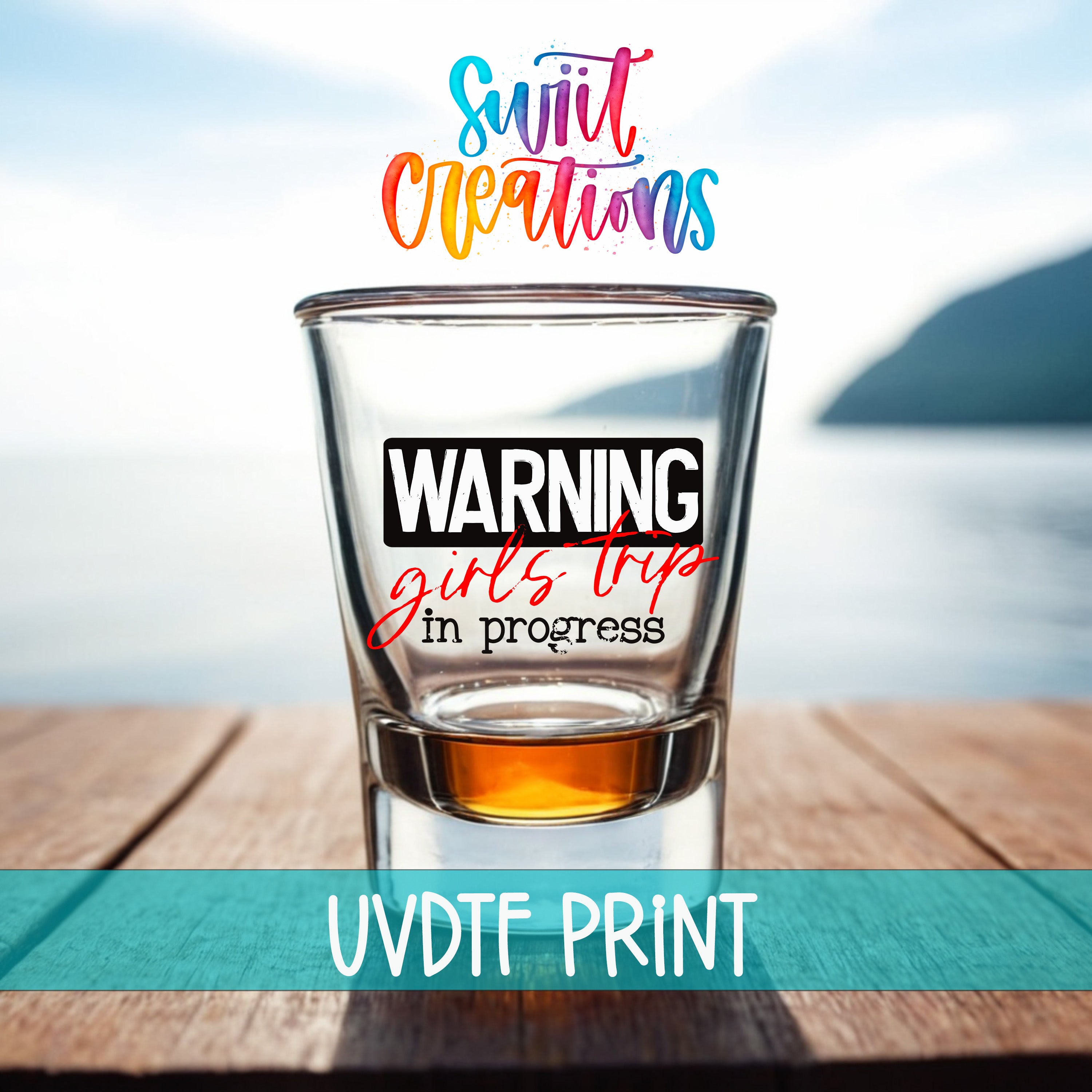 a shot glass with a warning label on it, placed on a wooden surface with a body of water in the background.