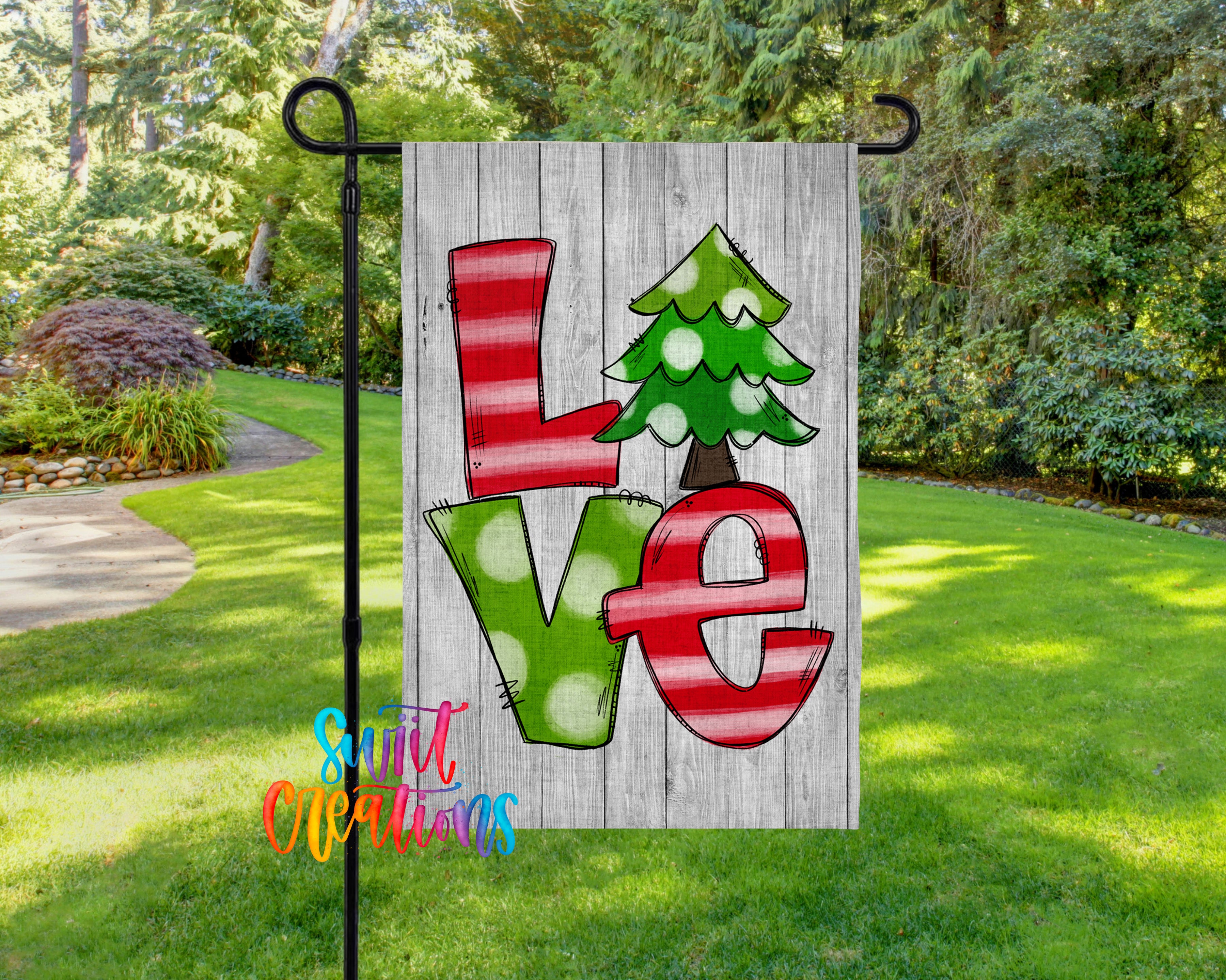A flag with the word "LOVE" written on it, featuring a Christmas tree design.