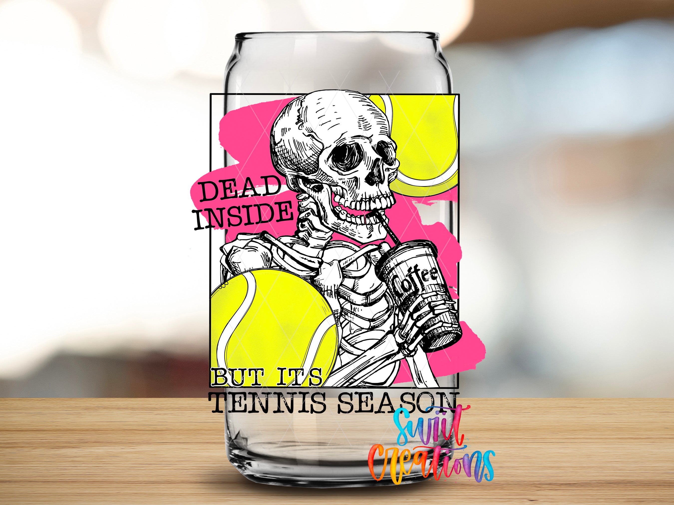 A glass can with a design featuring a skeleton holding a cup of coffee and tennis balls, along with the text "Dead inside but its tennis season".