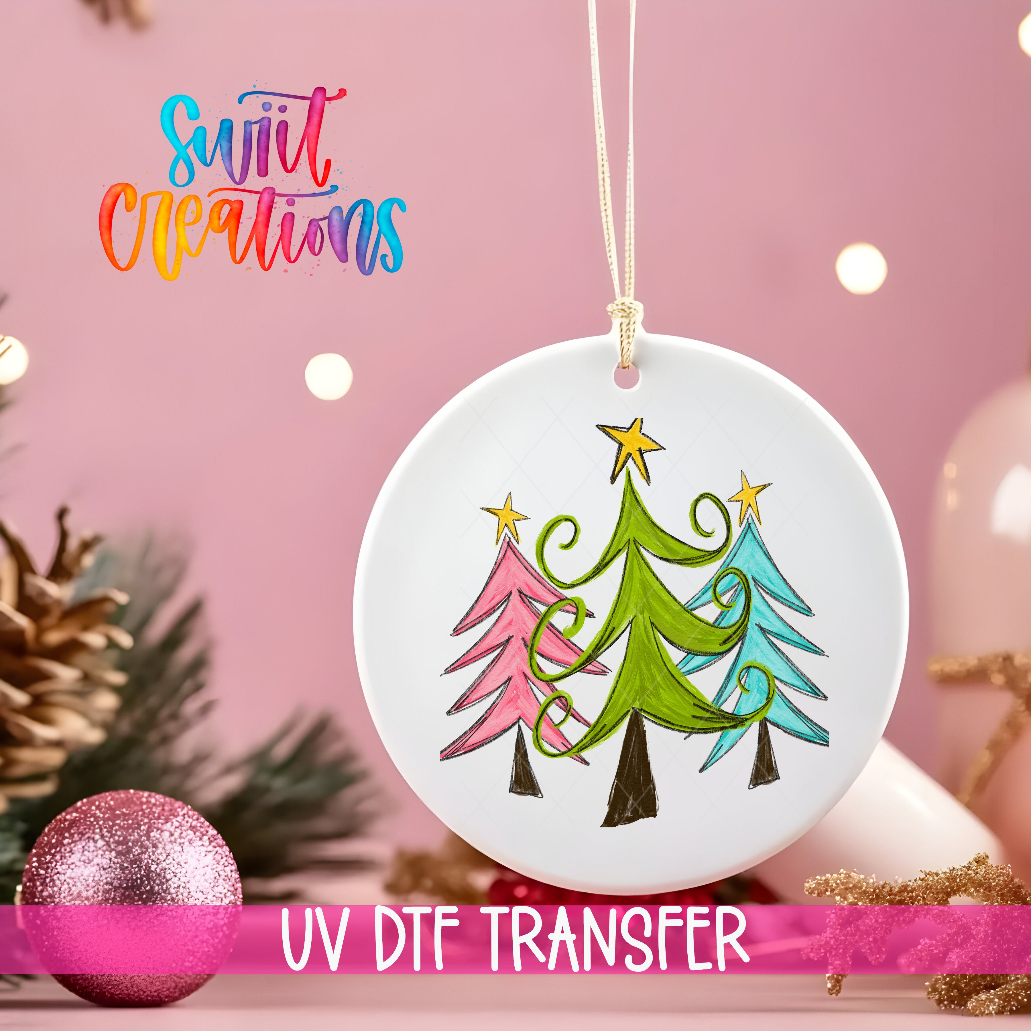 A white ceramic ornament with a colorful illustration of three Christmas trees hangs against a pink background.