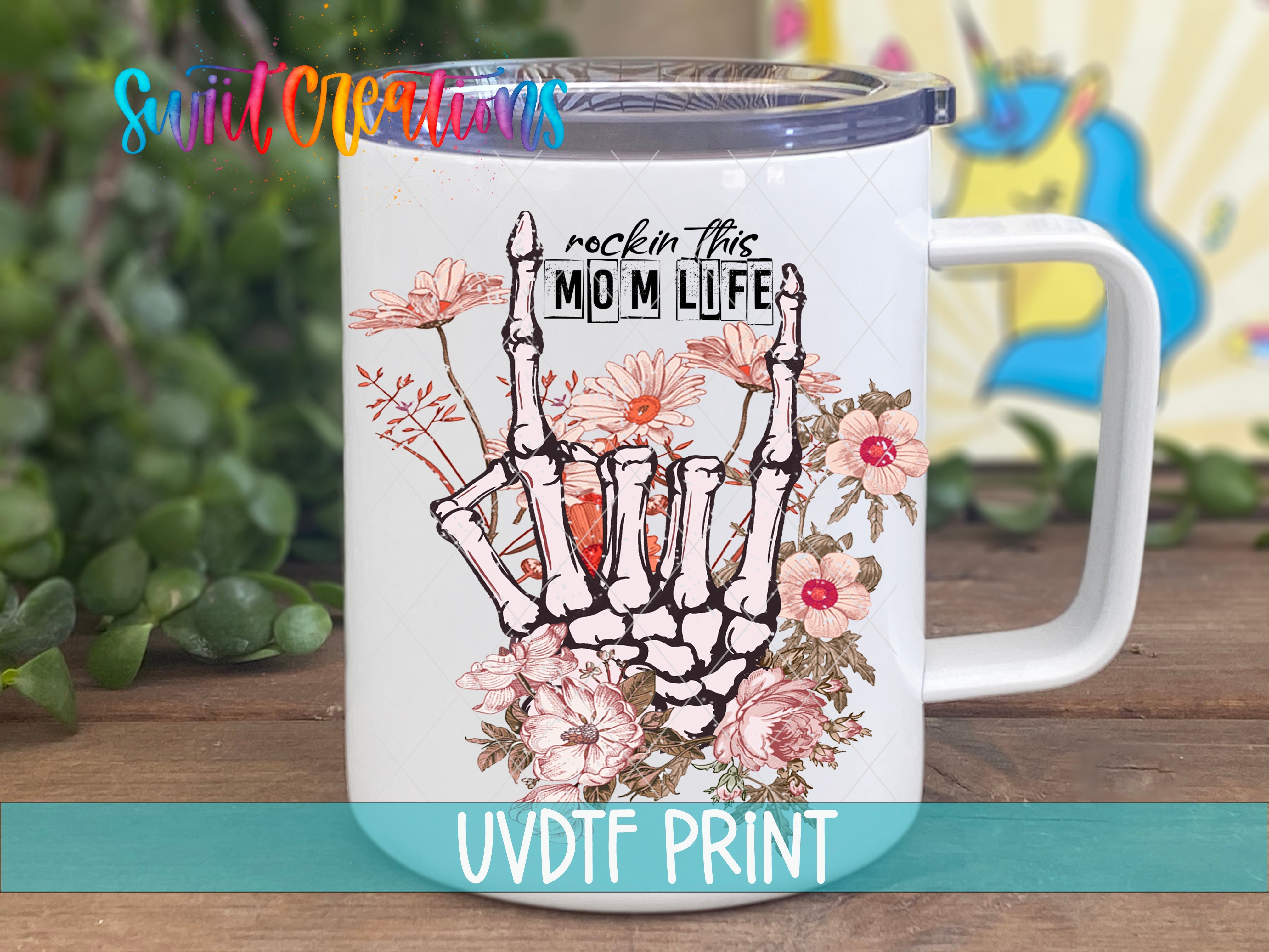 a white coffee mug with a hand holding flowers