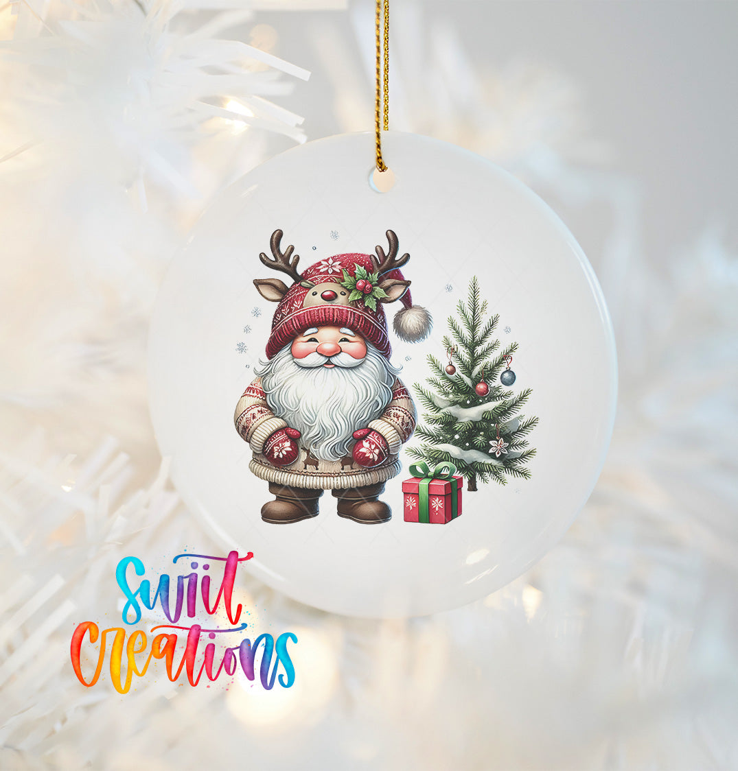 A white ornament featuring a gnome wearing a red hat and holding a gift box, standing next to a Christmas tree.