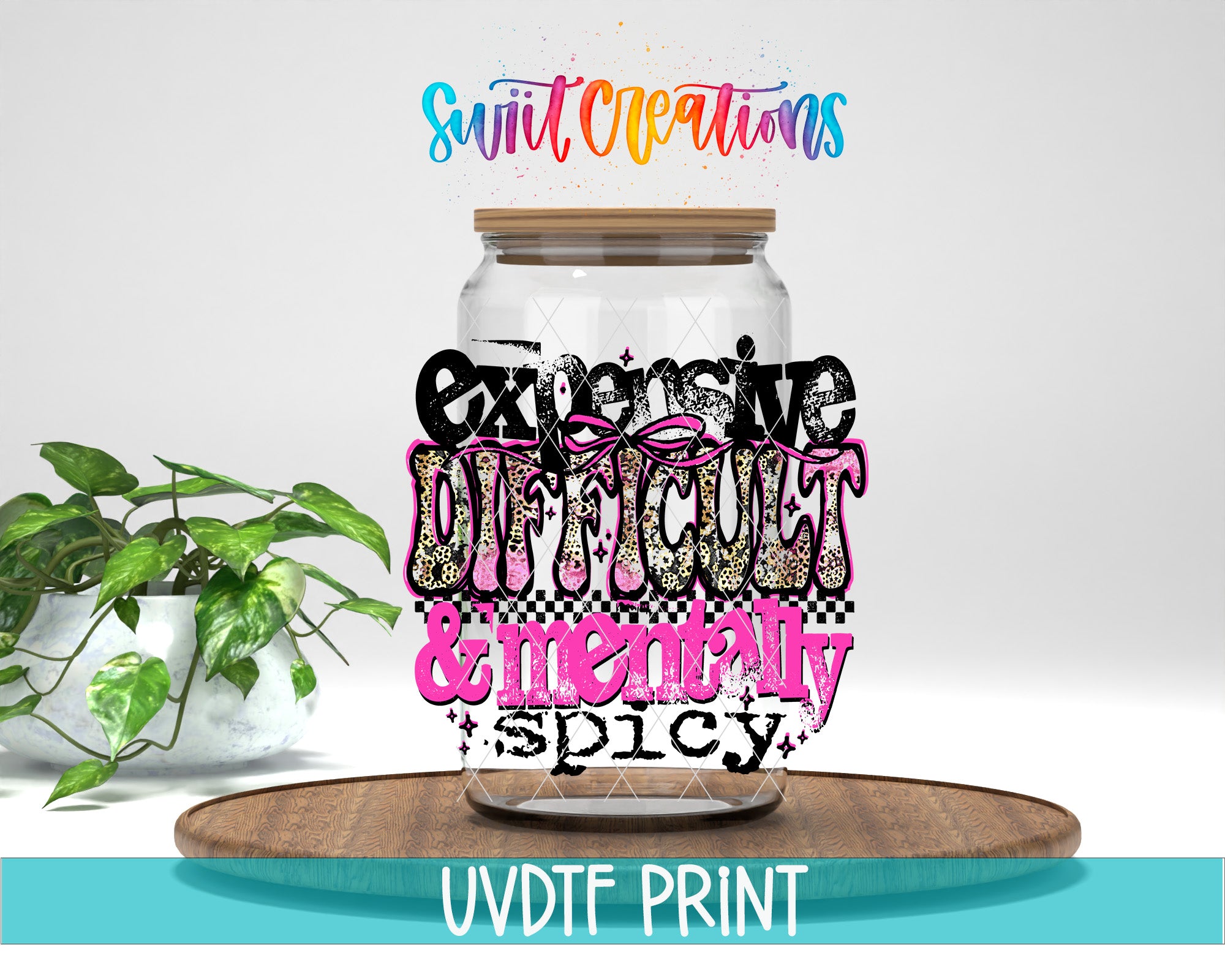 a large glass jar with a lid, surrounded by a potted plant and a wooden tray. The jar has a colorful, artistic design with text that reads "expensive, difficult, & mentally spicy".