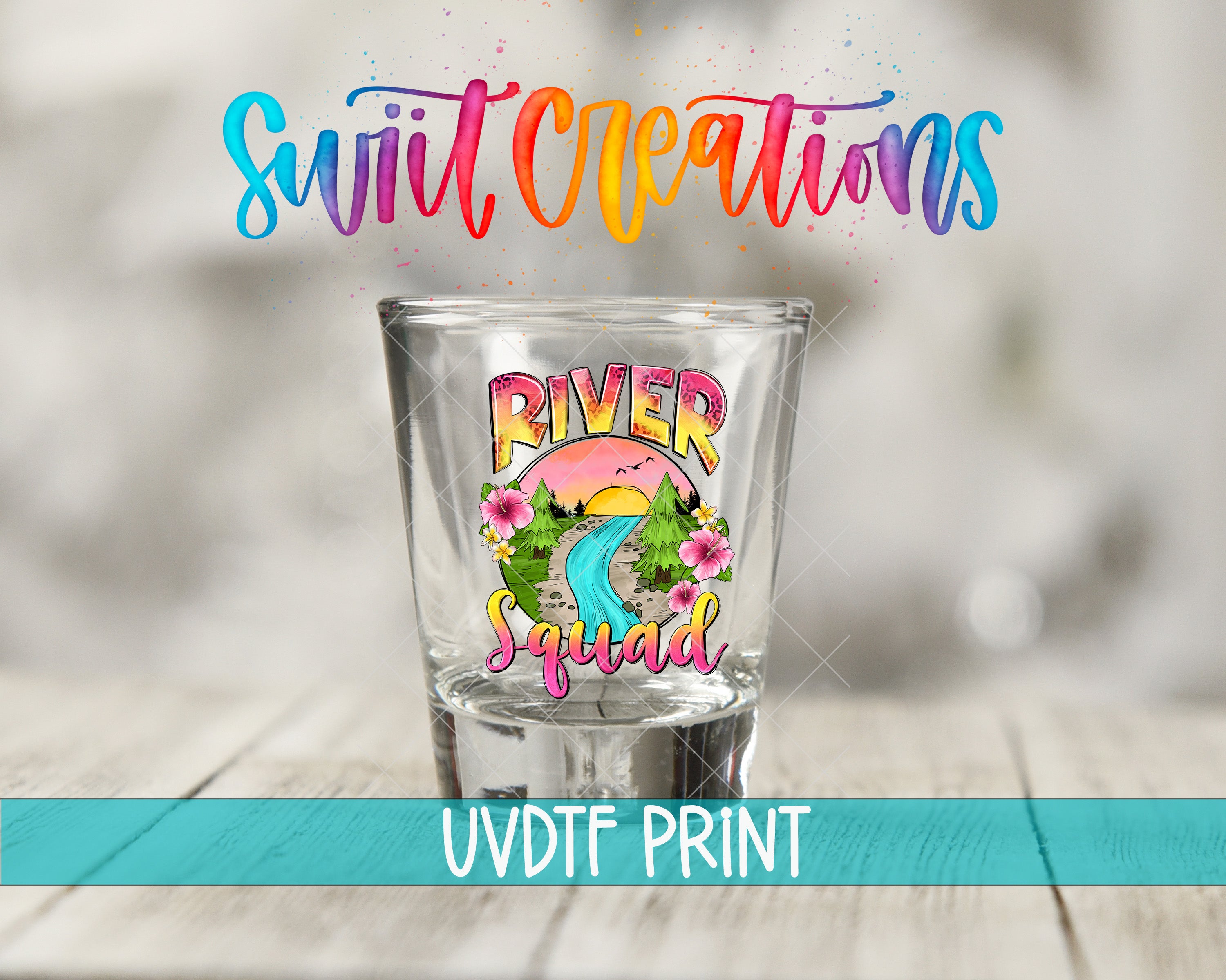 a shot glass with a colorful design and text, placed on a wooden surface.