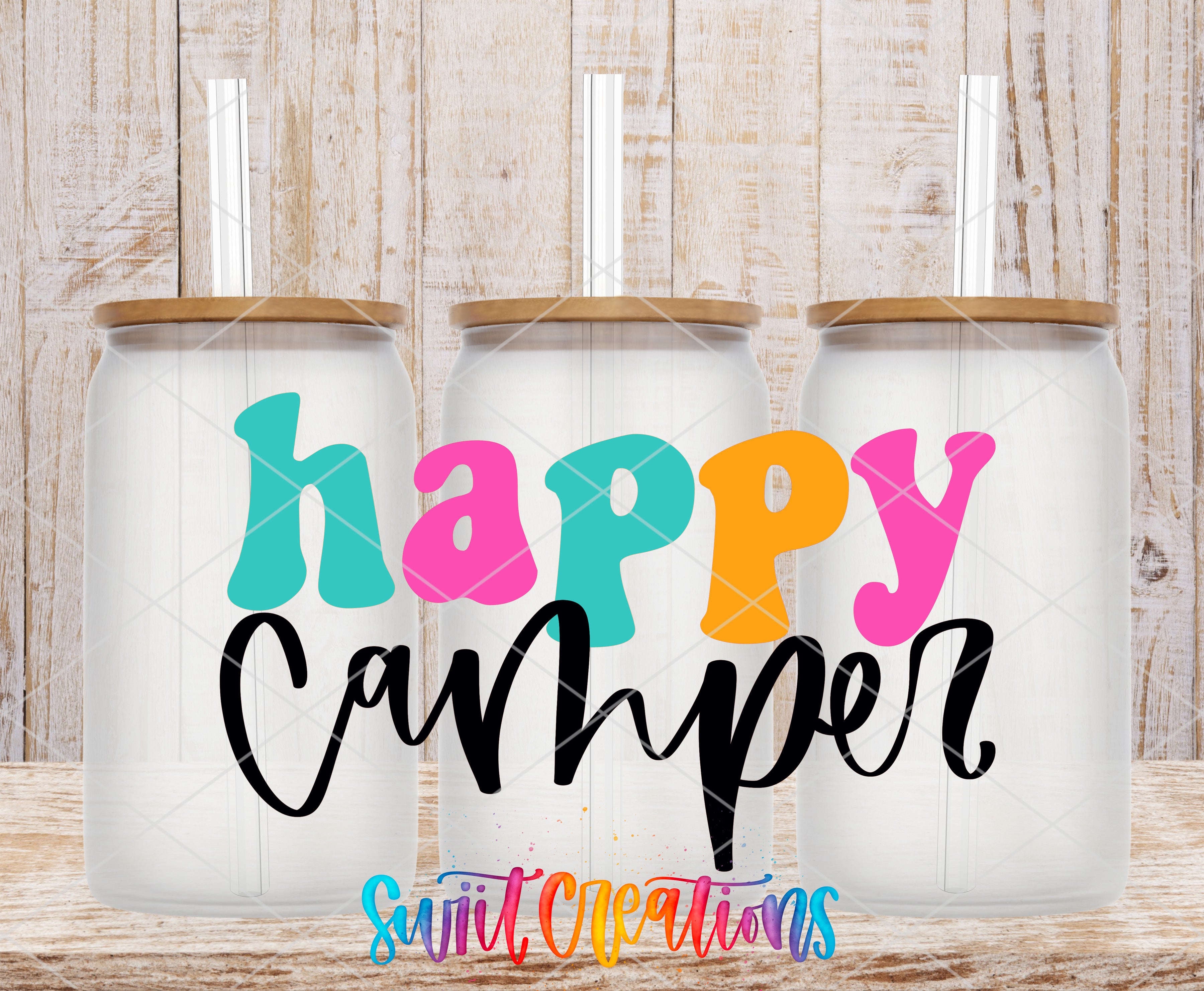 three colorful glass jars with straws, each containing a drink, arranged in a row against a wooden background.