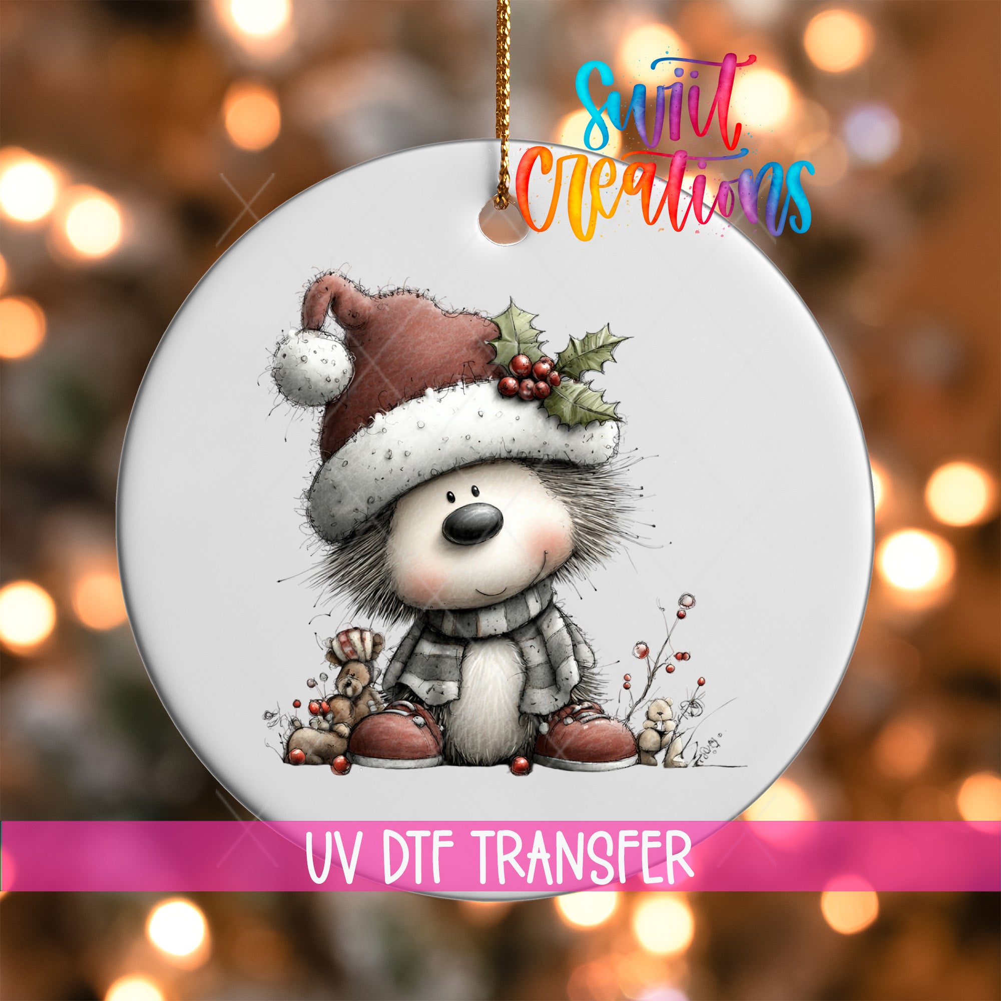 A white ornament with a cartoon illustration of a smiling hedgehog wearing a Santa hat and scarf, set against a blurred background with Christmas lights.