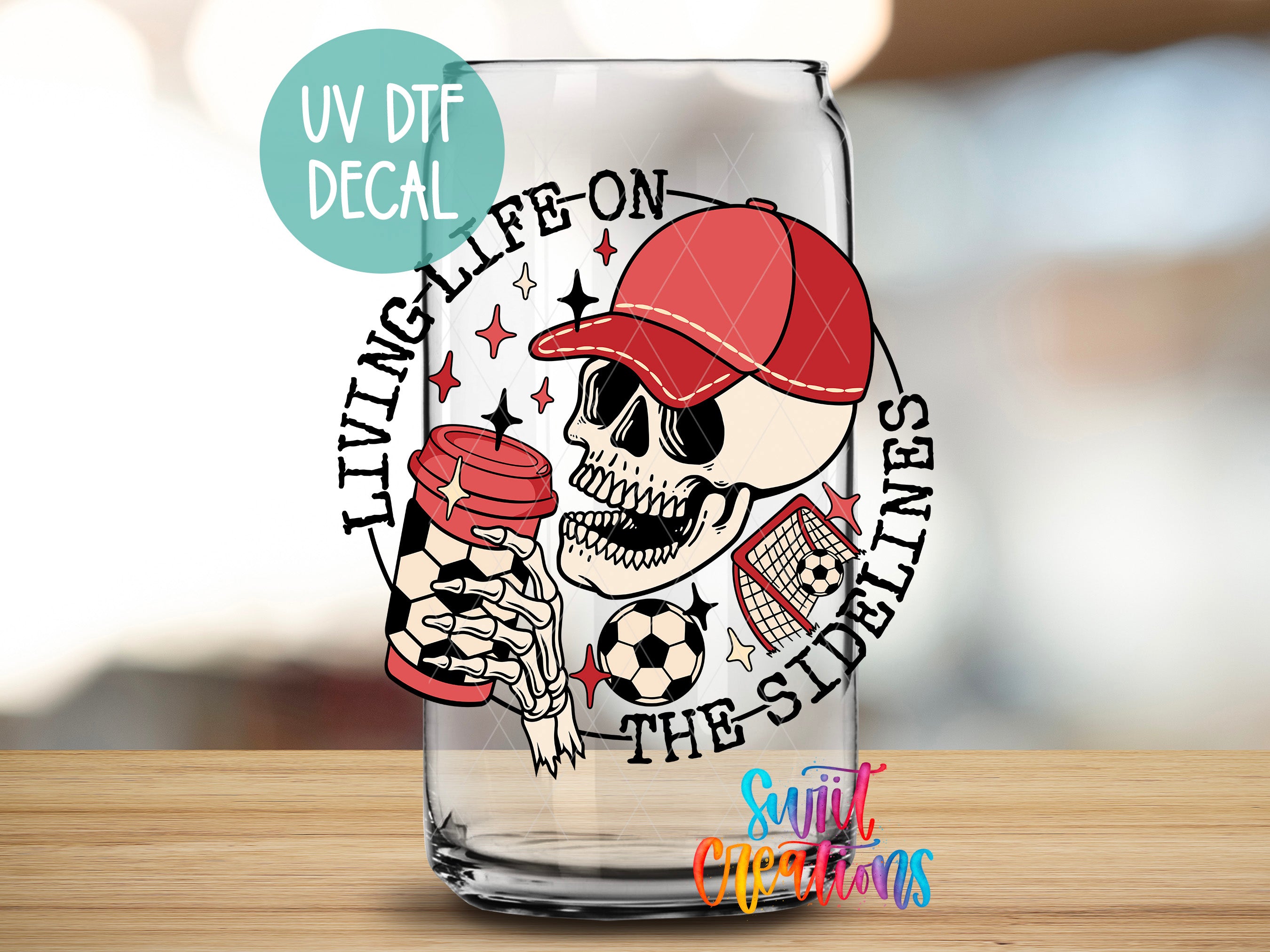 a glass with a skull holding a soccer ball