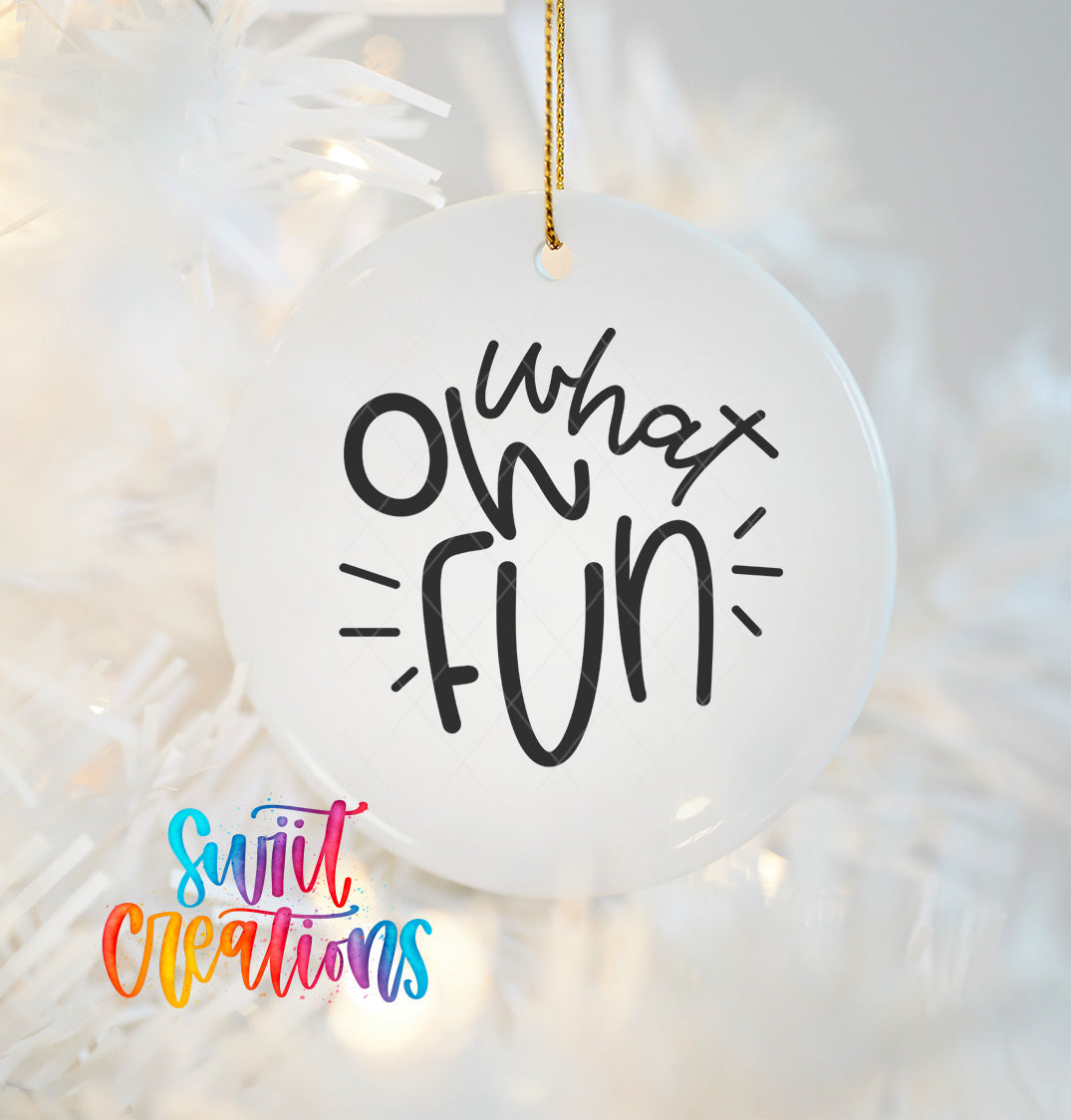 A white ornament with the text "What's fun" written on it, hanging on a string.