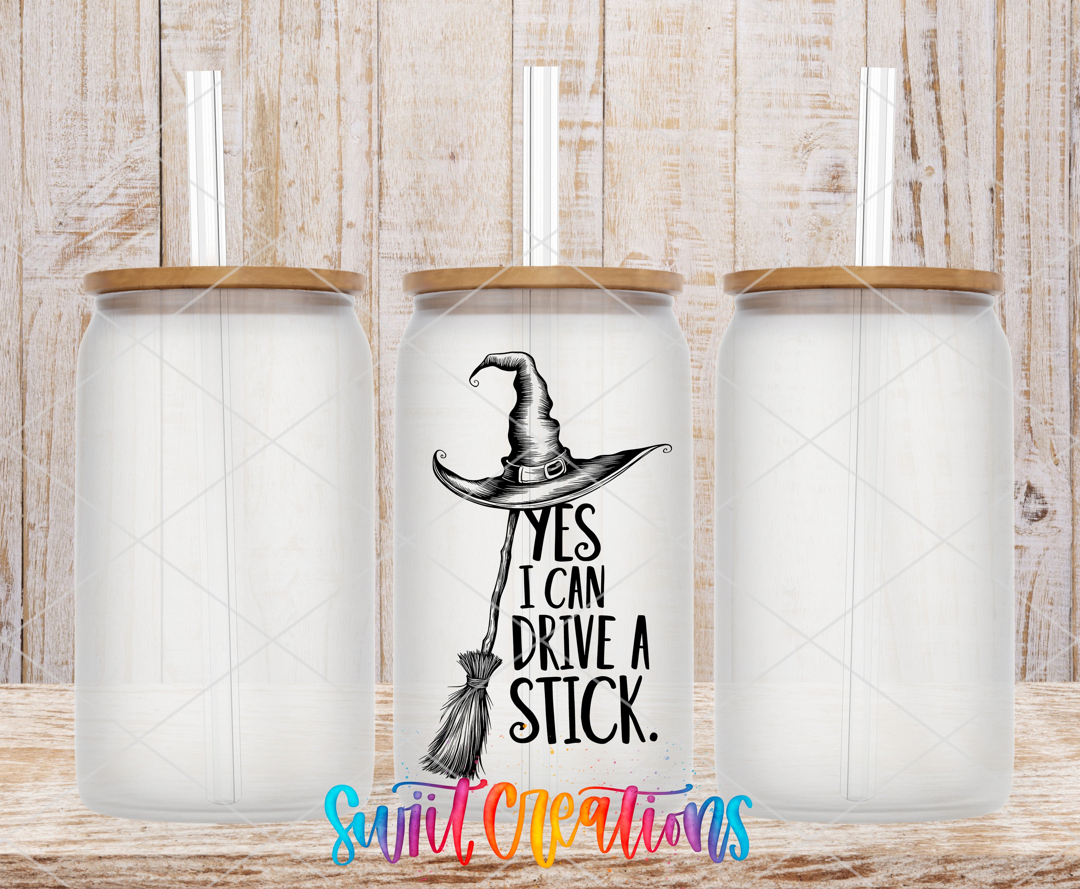 A tumbler with a witch's broom and the text "YES I CAN DRIVE A STICK" printed on it, along with a straw.