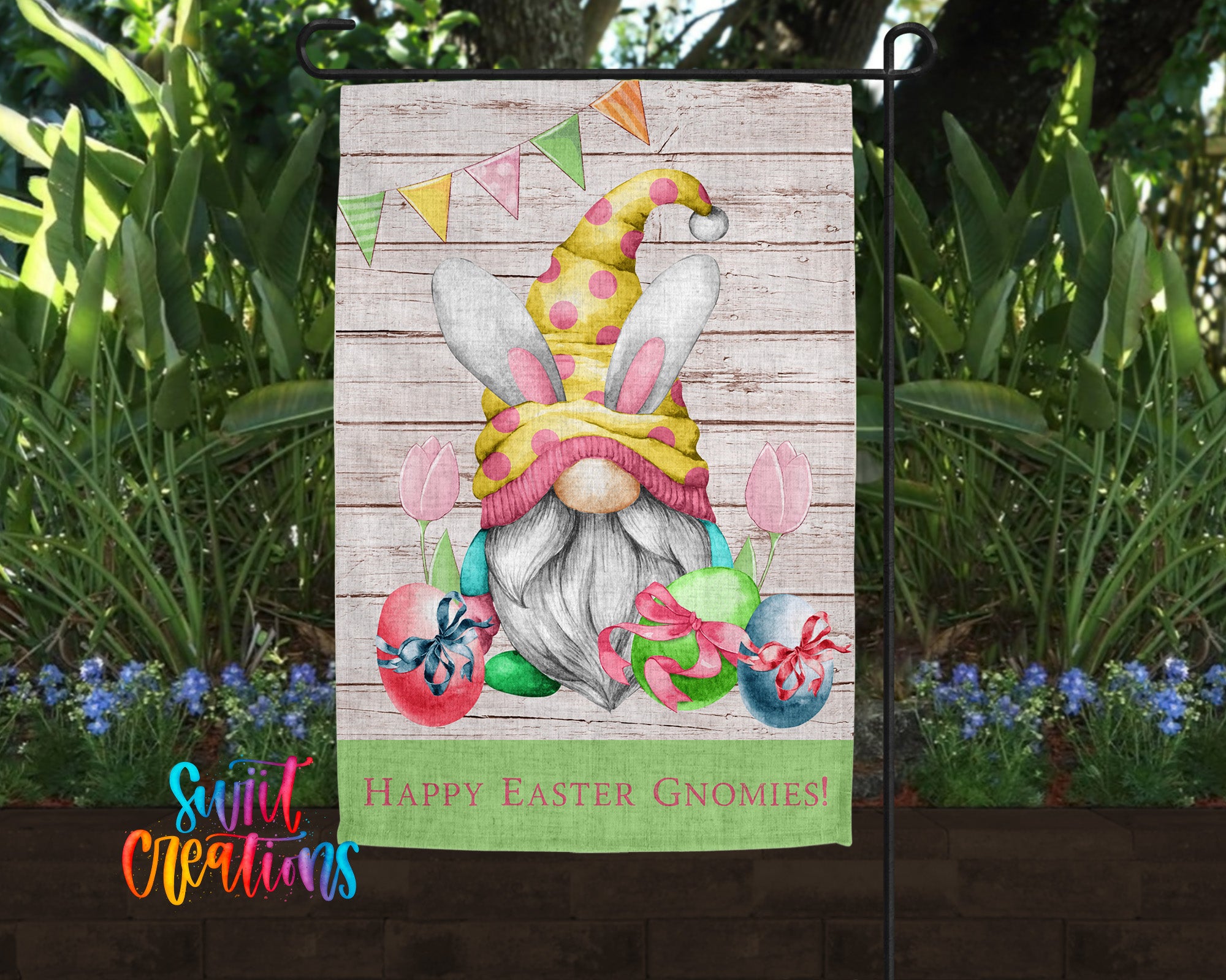 A garden gnome wearing a yellow hat with a pink bunny ear and holding a green egg and a red bow, surrounded by colorful Easter eggs and flowers, with a banner that says "Happy Easter Gnomes!"